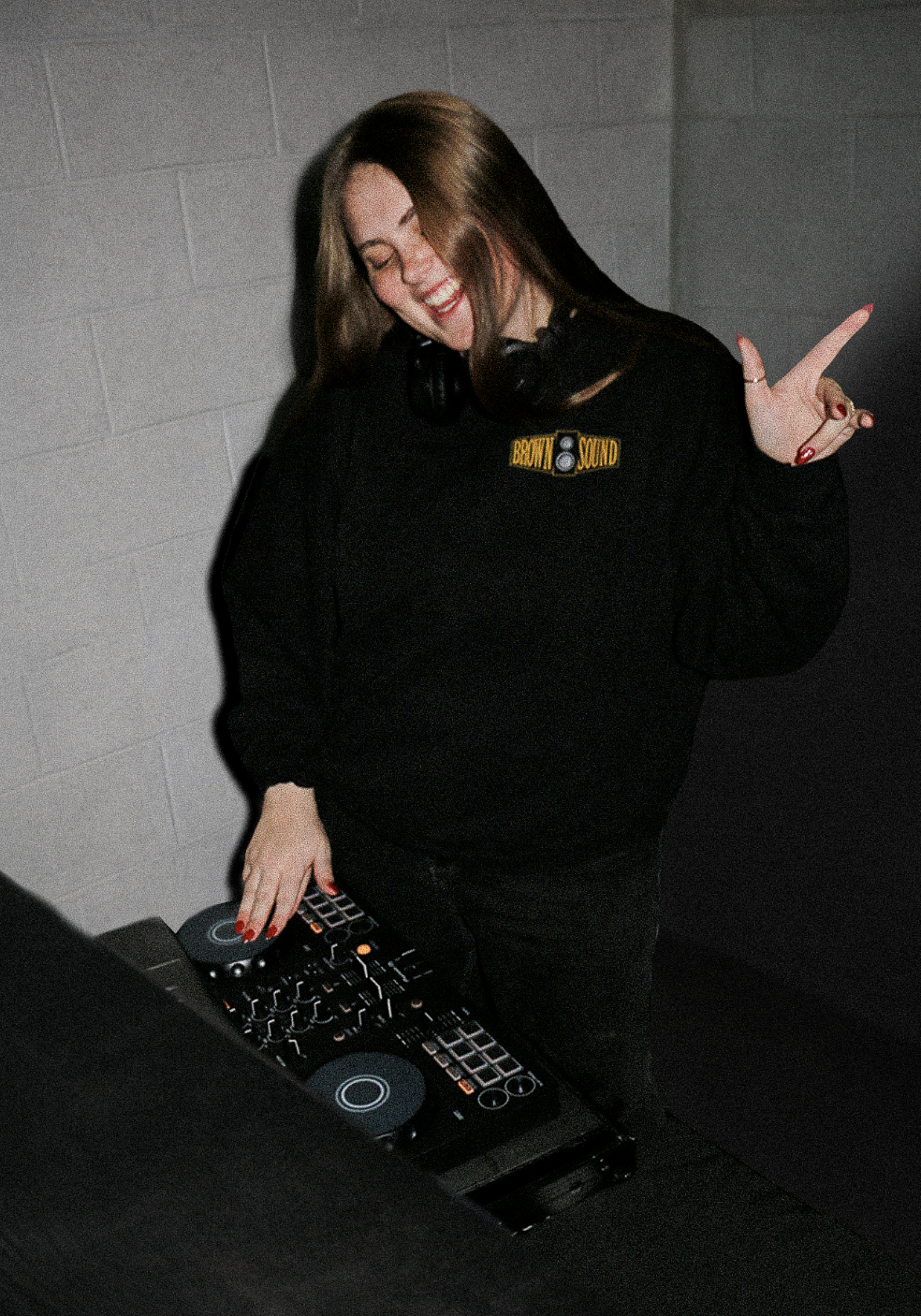 CC from Brown Sound at the DJ controller wearing a Brown Sound sweatshirt