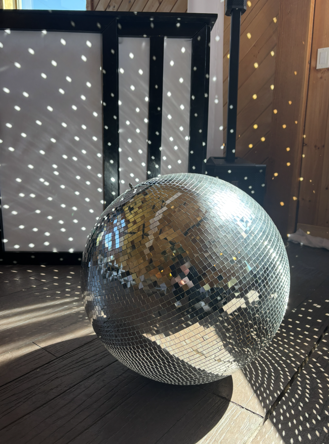 Disco ball catching light on the dance floor at a Brown Sound wedding reception