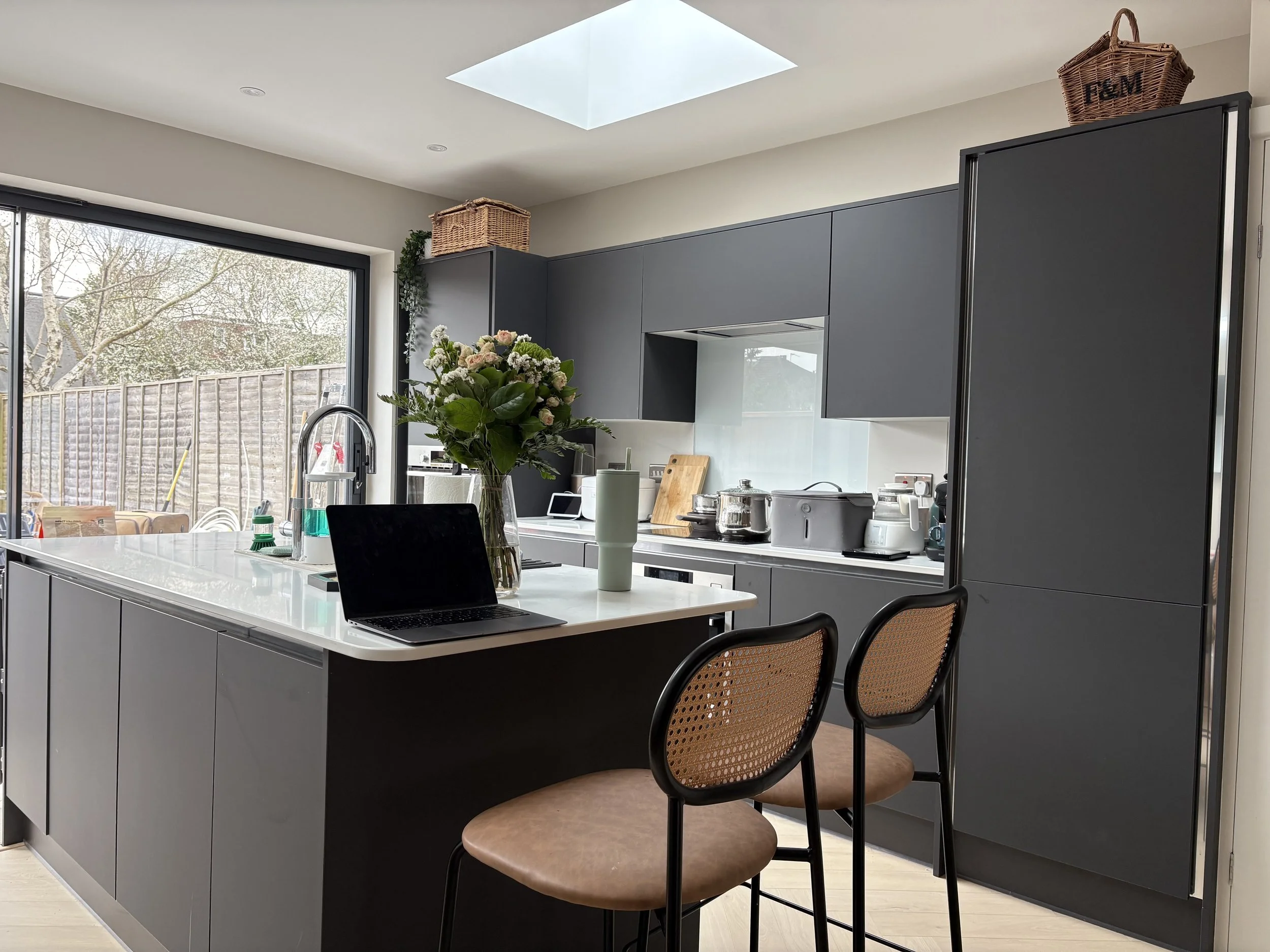 Graphite kitchen island and integrated appliance wall