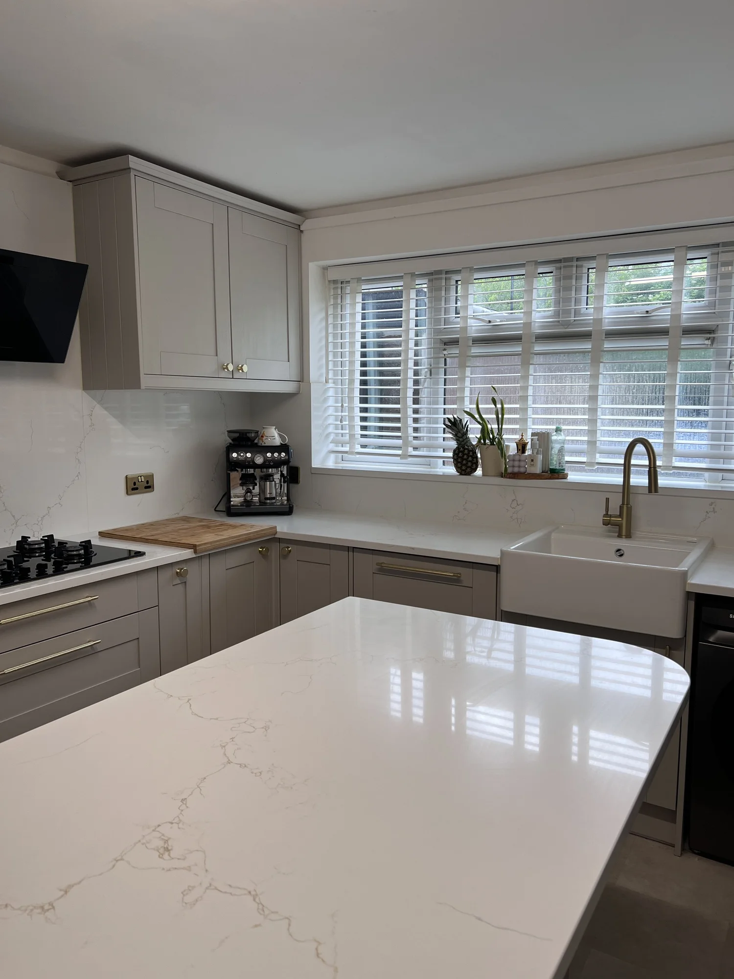 Close view of pale quartz and tailored Shaker cabinetry