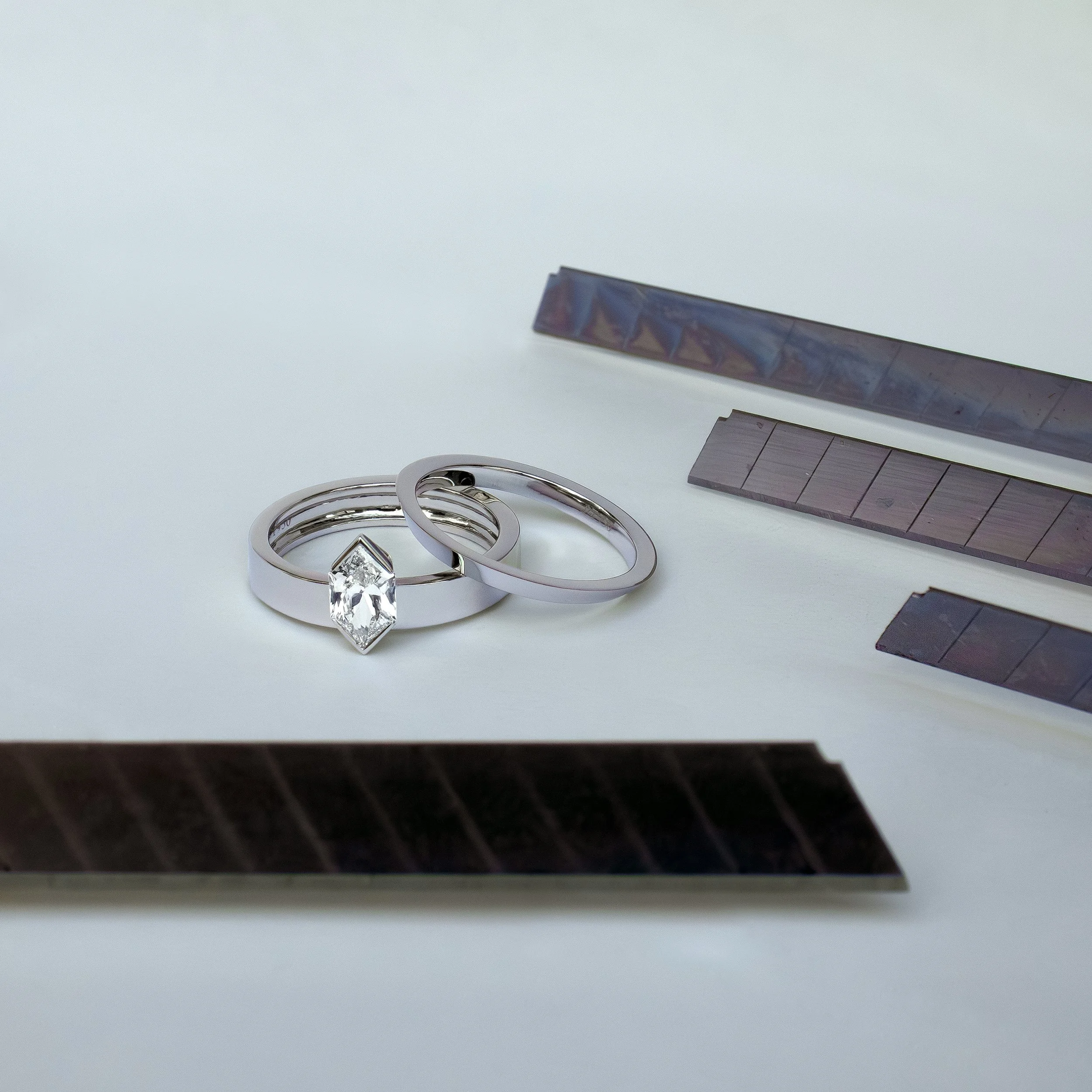 Platinum ring set featuring a Dutch-cut marquise brilliant diamond photographed with cutting blades on a white background.