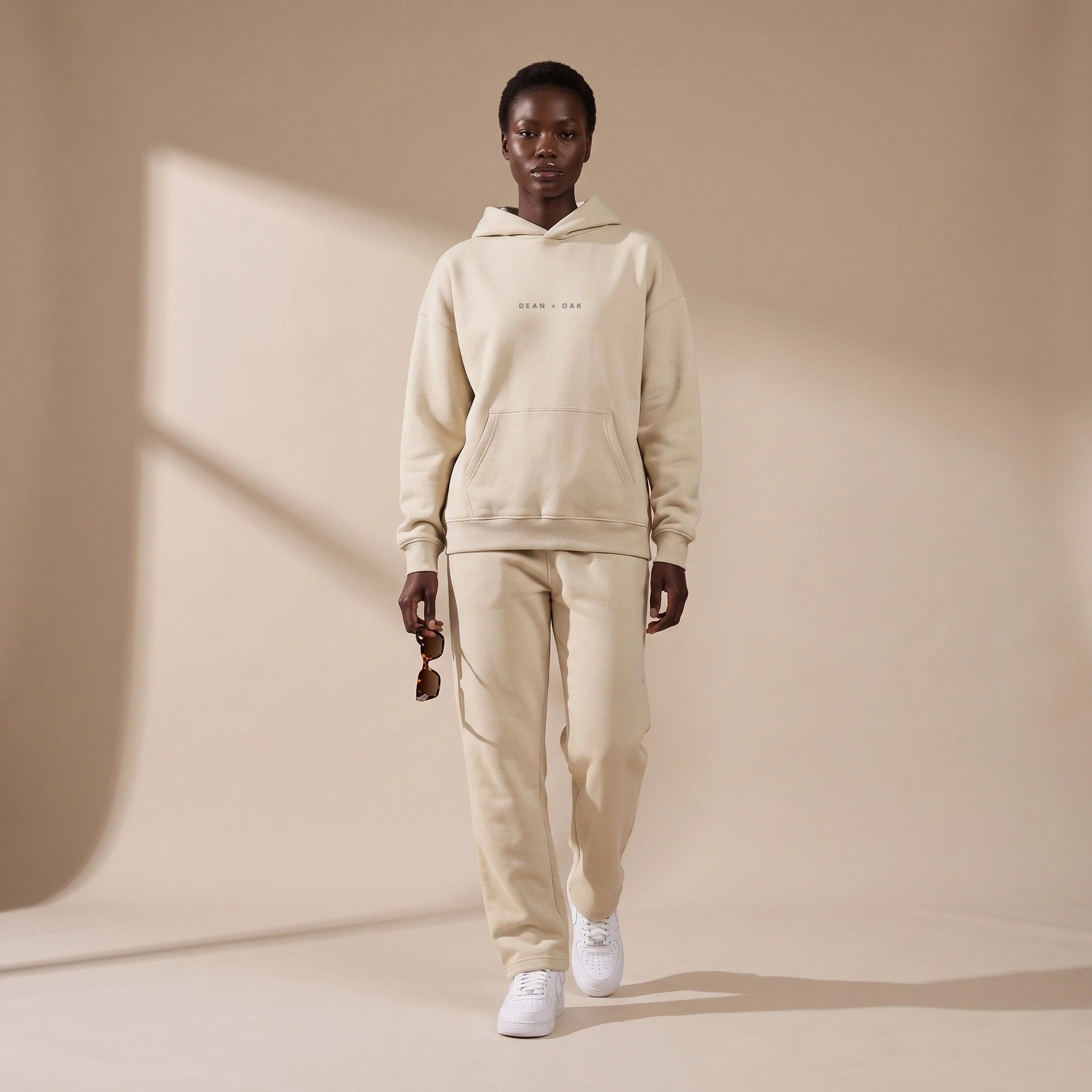 Dean + Oak heavyweight fleece hoodie in Sand, worn on a model