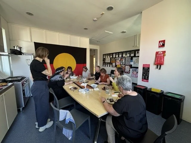 GDIIN members around a large table during an in person meeting