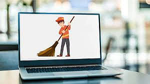 Laptop displaying cartoon of person sweeping with a broom