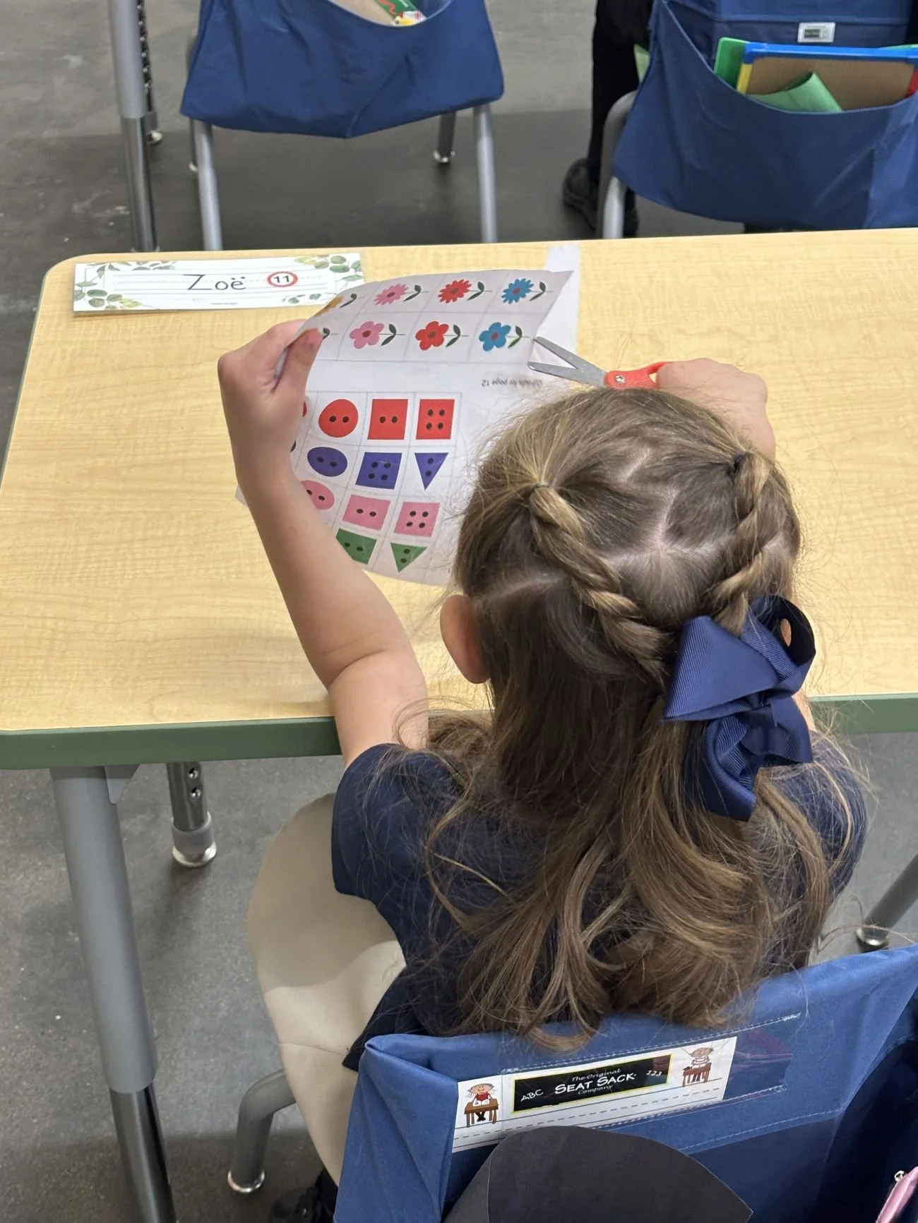Student cutting paper in class Elko