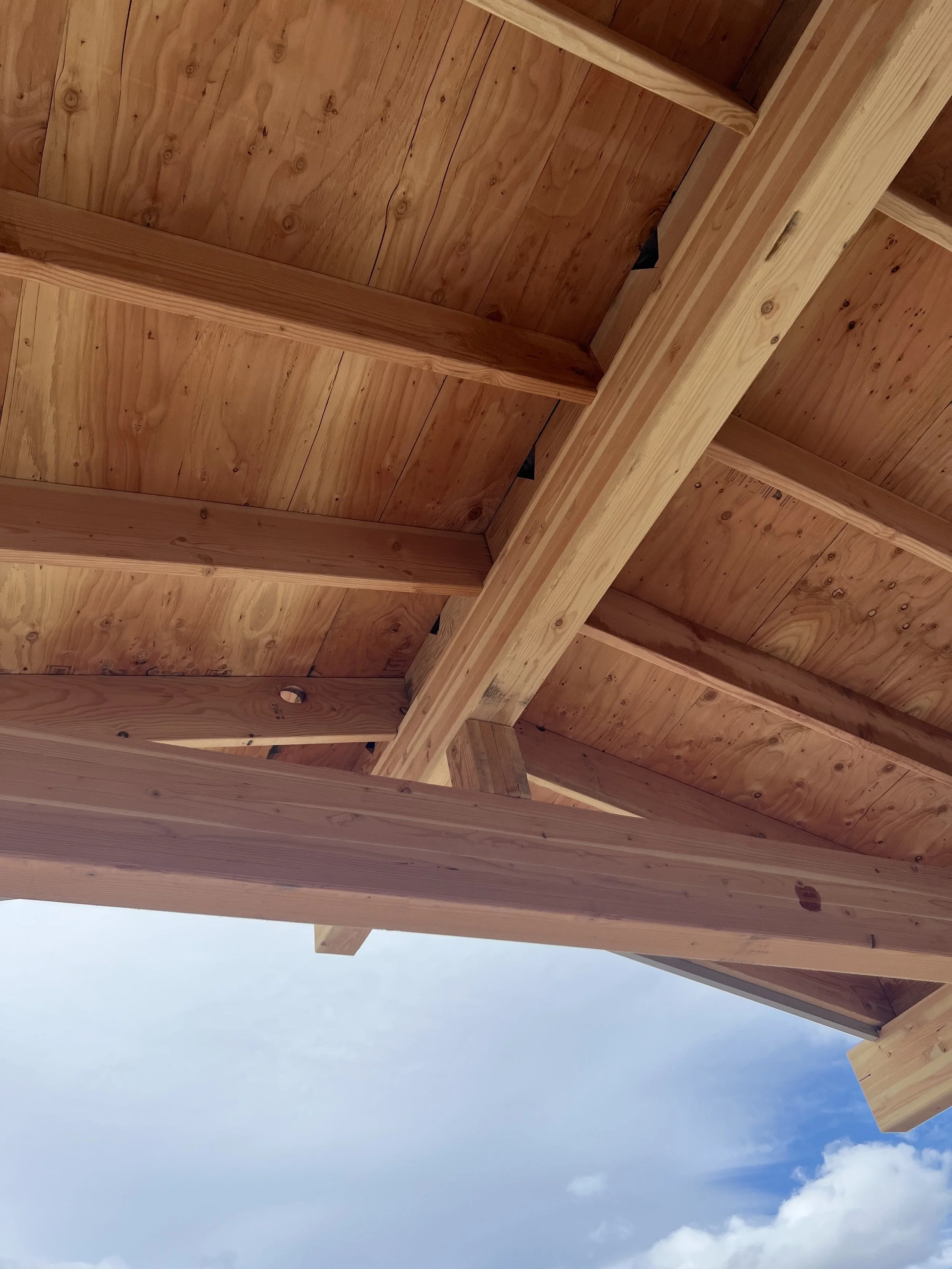Exposed wood rafter tails and tongue-and-groove soffit construction detail. Detailed view of the roof overhang construction. 