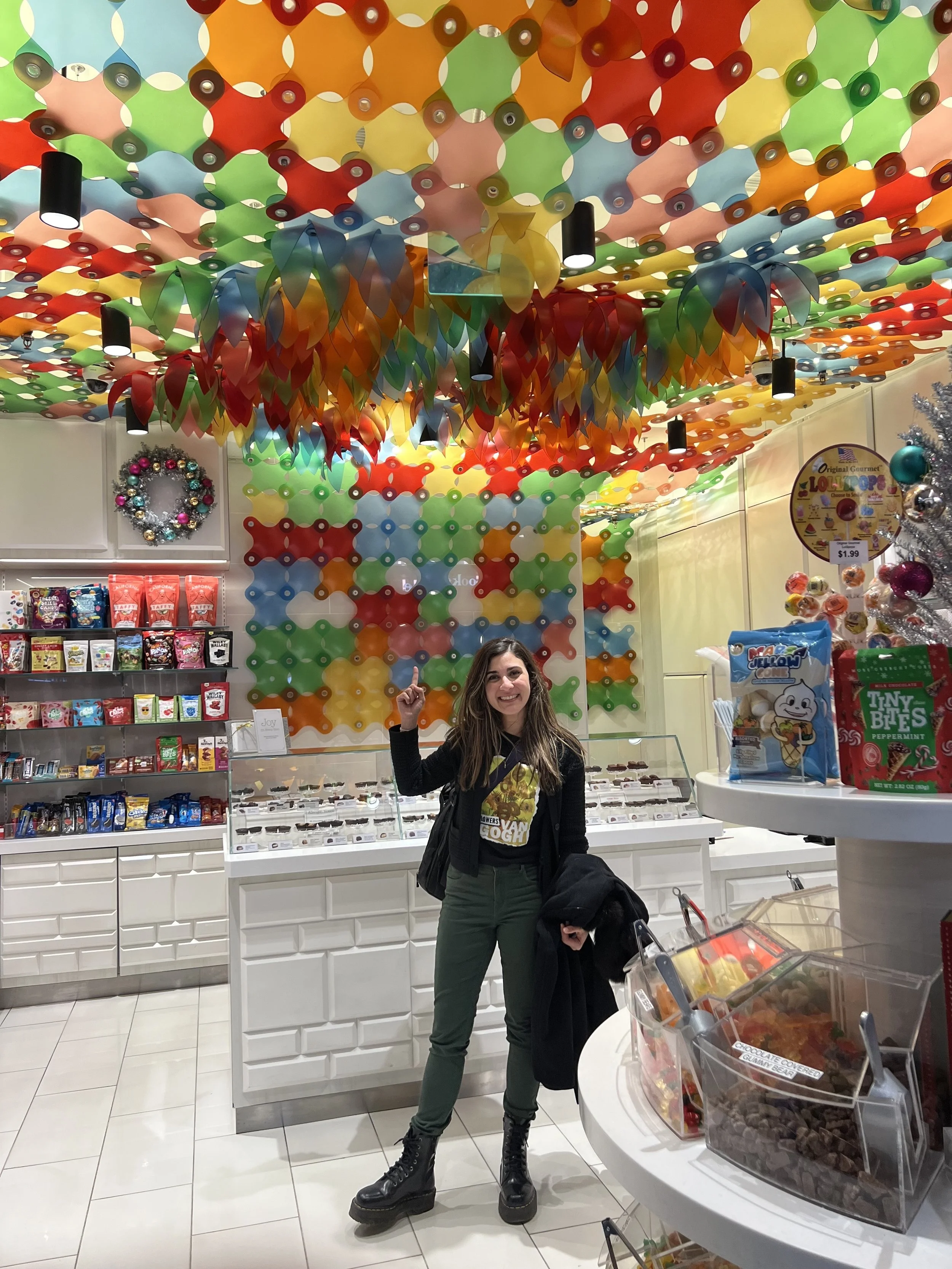 Immersive retail experience featuring a custom kinetic ceiling installation designed to capture traveler attention from the concourse.