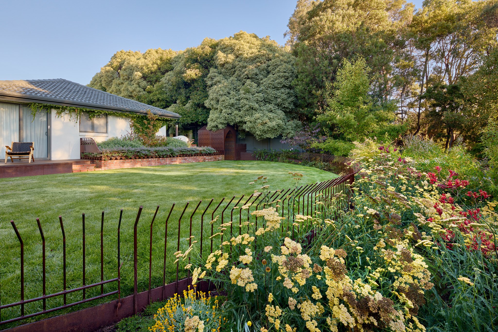 This fence has become a quiet favourite of ours.

Light, understated, and just enough to do its job &mdash; keeping the chooks off the lawn and the kids on the lawn, without interrupting the flow of the garden.

It defines space without closing it in
