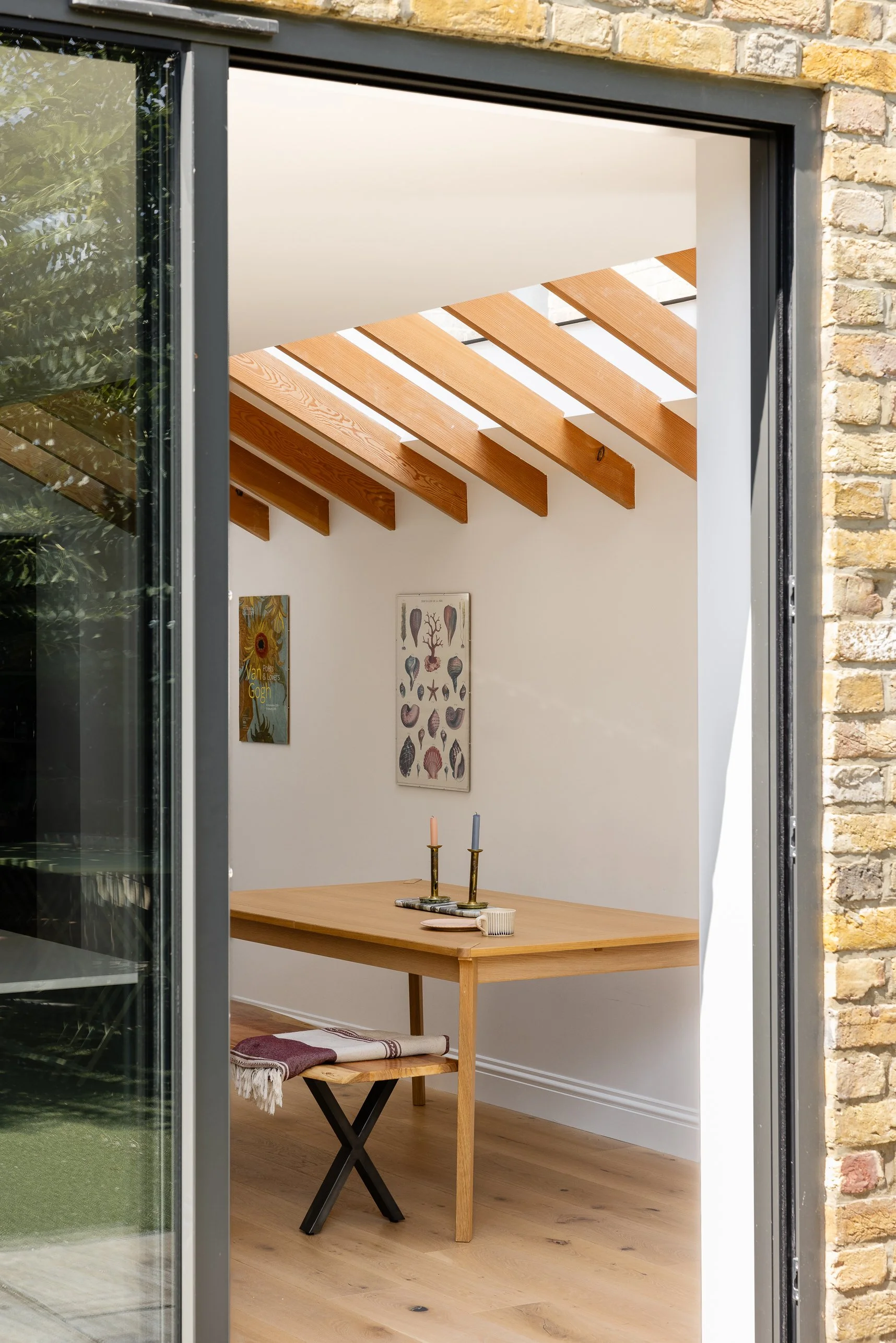 Rear of the London family home showing new dark-framed glazing set within the existing brick elevation.