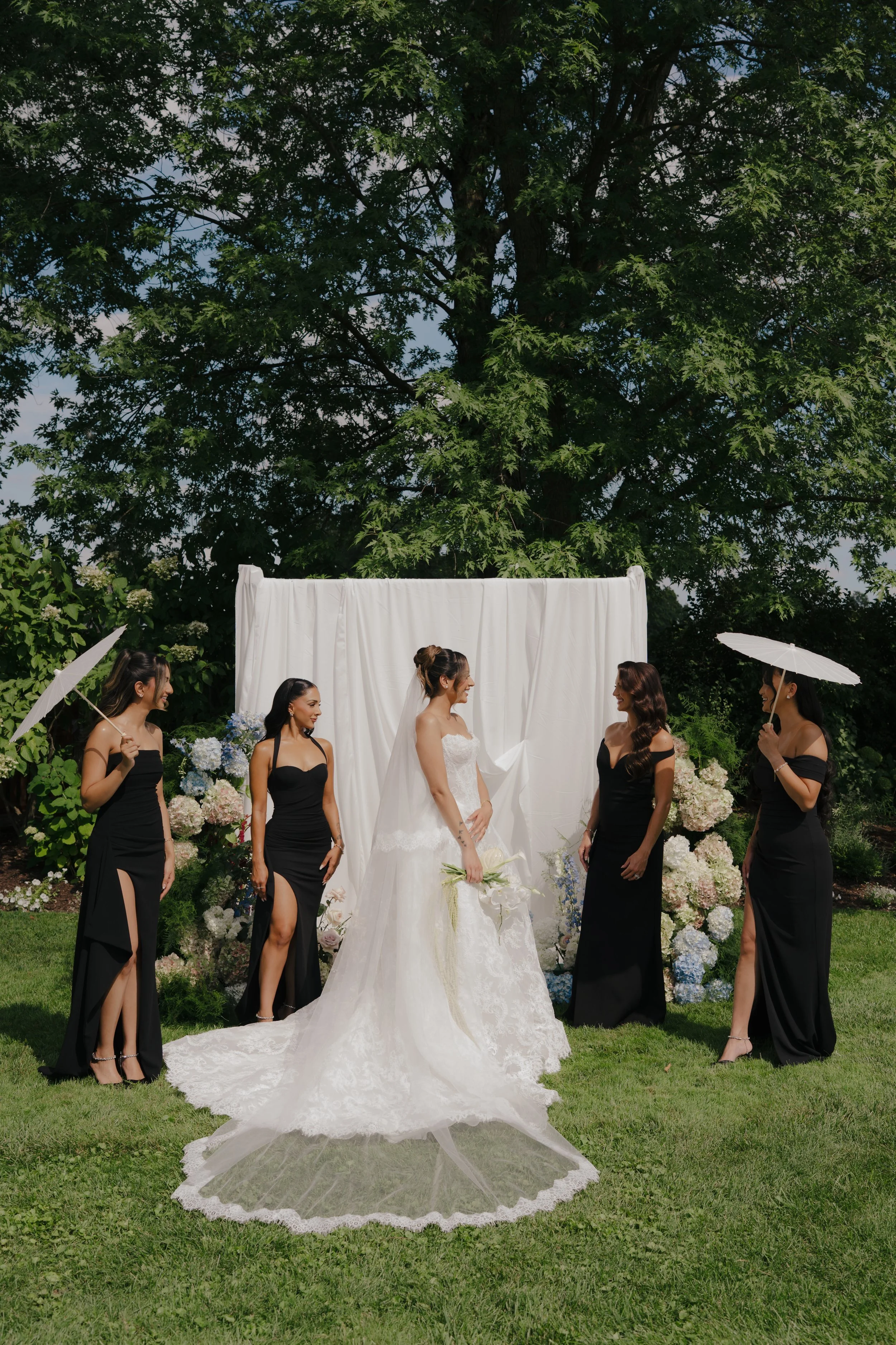 Draped wedding installation with lush florals designed by Dereves Studio for elevated Toronto wedding décor.