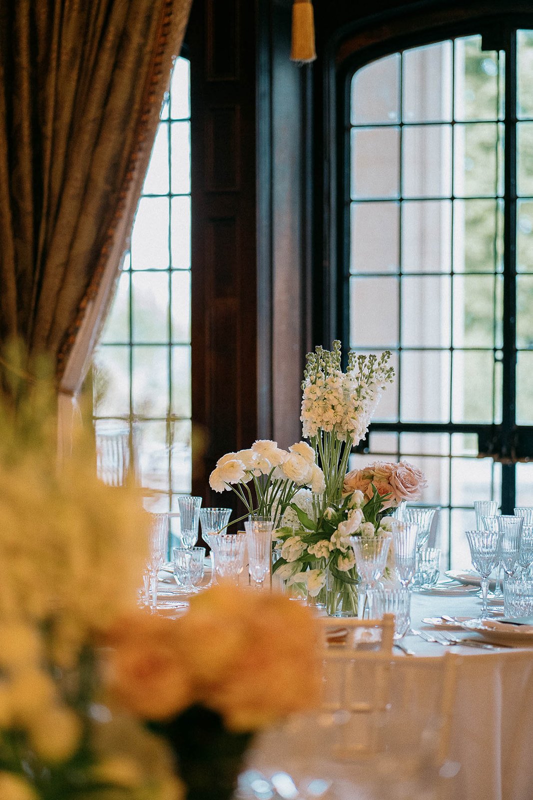 Romantic reception filled with candles, glass hurricanes, and full floral décor by Dereves Studio, showcasing luxury wedding planning Toronto and design methods that create an expensive, editorial-quality atmosphere