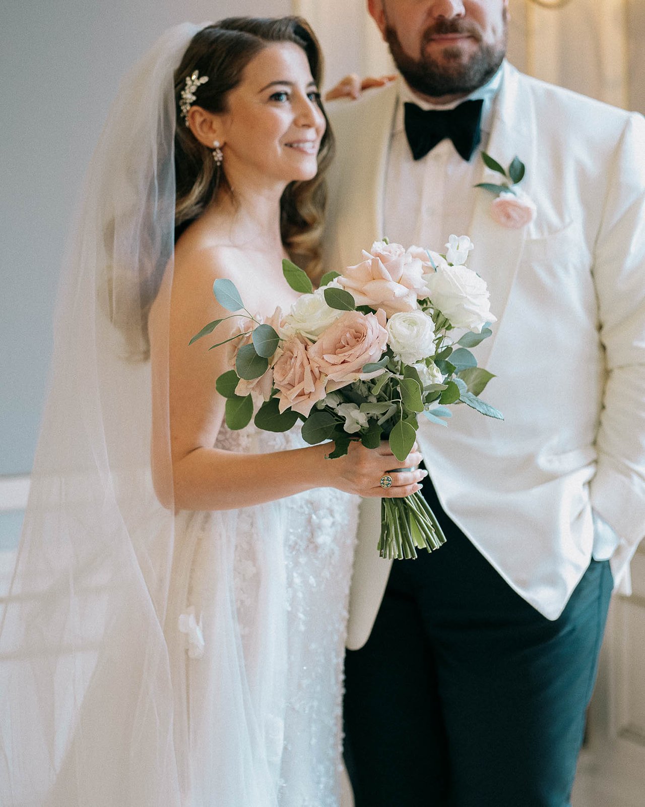 Couple with premium florals, bouquet, and layered textures by Dereves Studio, illustrating elevated wedding design Toronto and luxury wedding planning techniques that create a high-end, editorial celebration