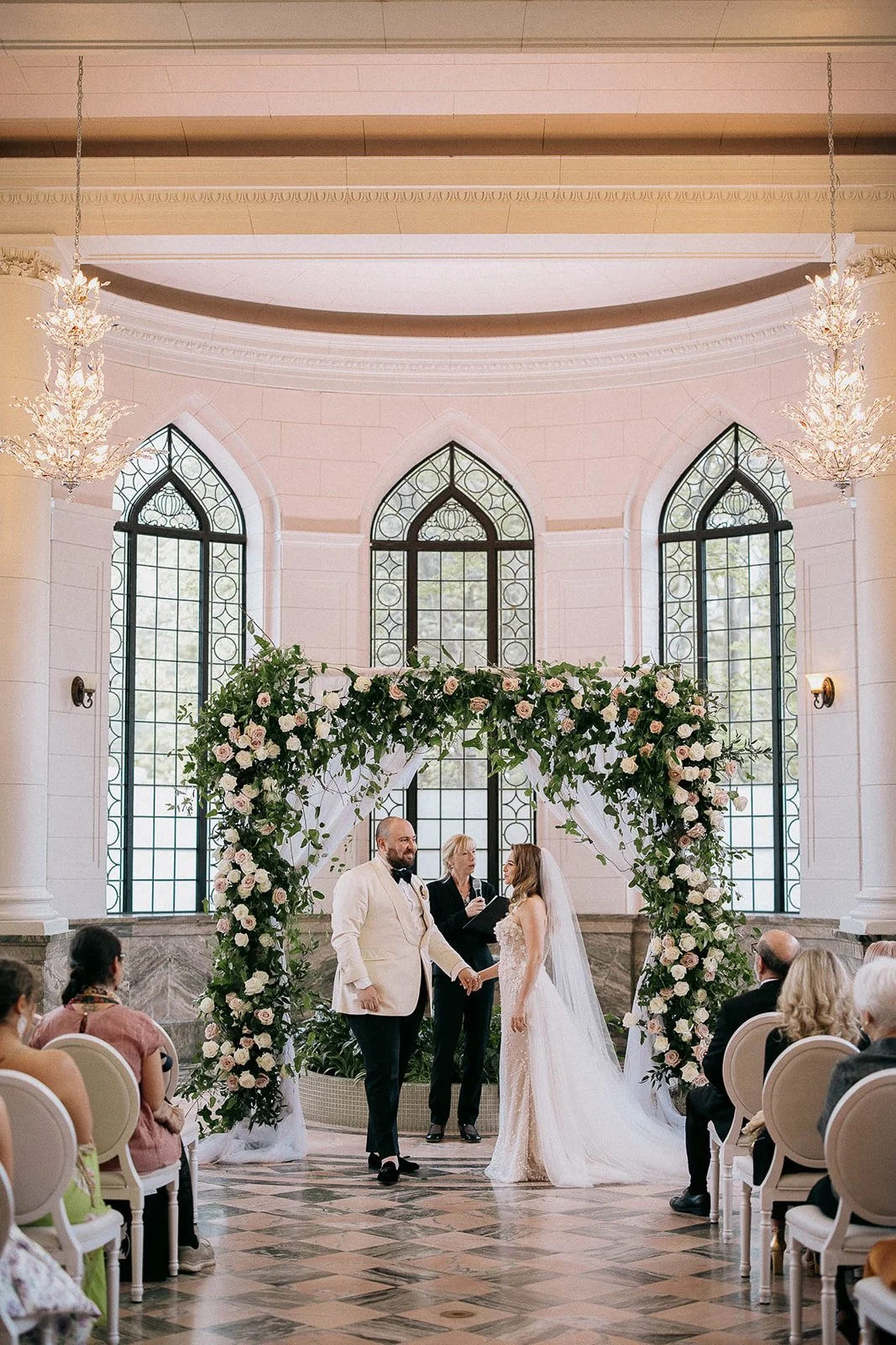 Luxury wedding ceremony arch created by Dereves Studio, a luxury wedding planner Toronto, featuring lush layered florals, premium roses, and sculptural greenery designed to help couples achieve an elevated, expensive-looking wedding aesthetic