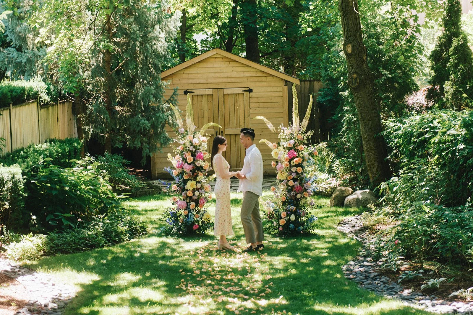 Colourful backyard proposal featuring vibrant floral arrangements and romantic outdoor styling by Derêves Studio, a Toronto wedding and event florist.