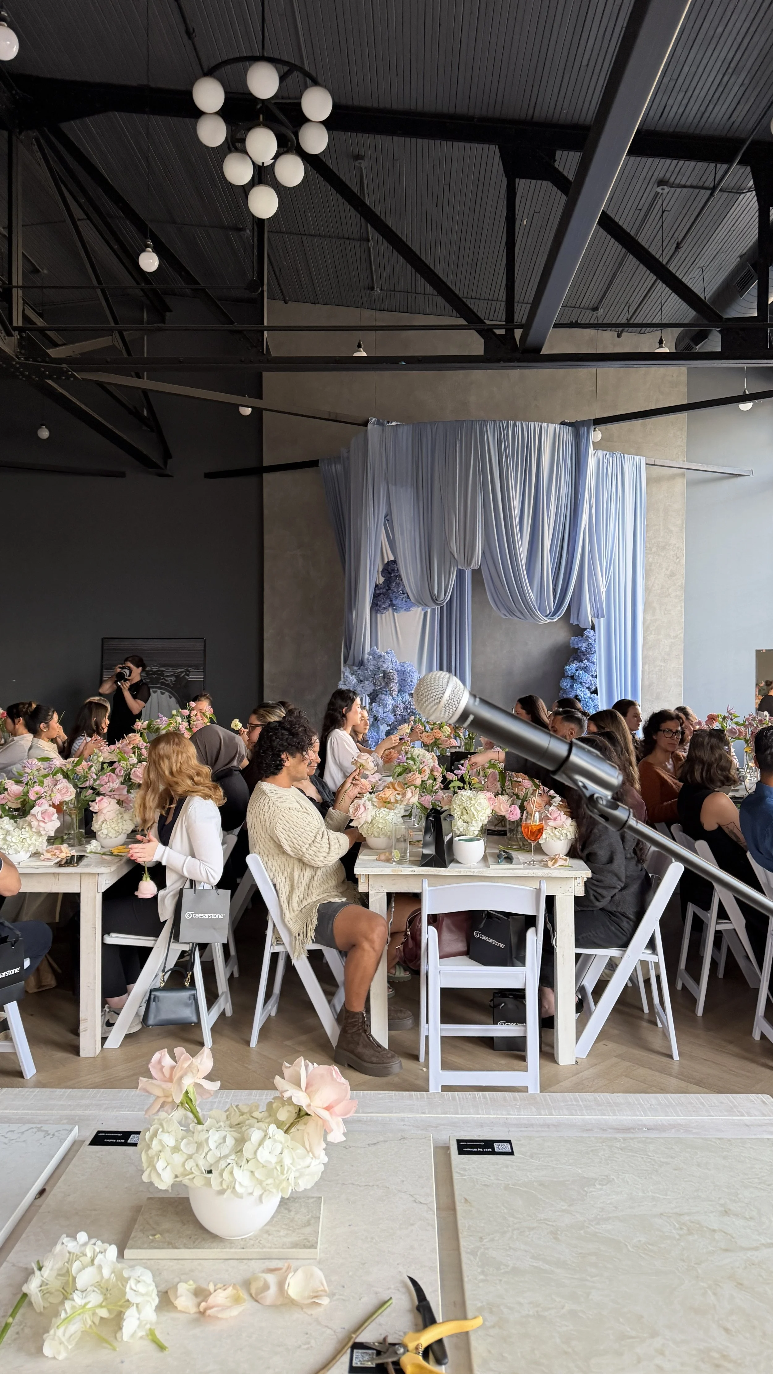 A branded flower workshop in a Toronto studio space featuring seasonal blooms and Caesarstone porcelain countertop material.