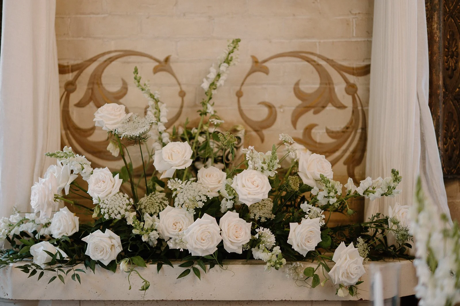 Lush ground florals framing the aisle created by Dereves Studio, highlighting rich, expensive-looking wedding flowers Toronto.