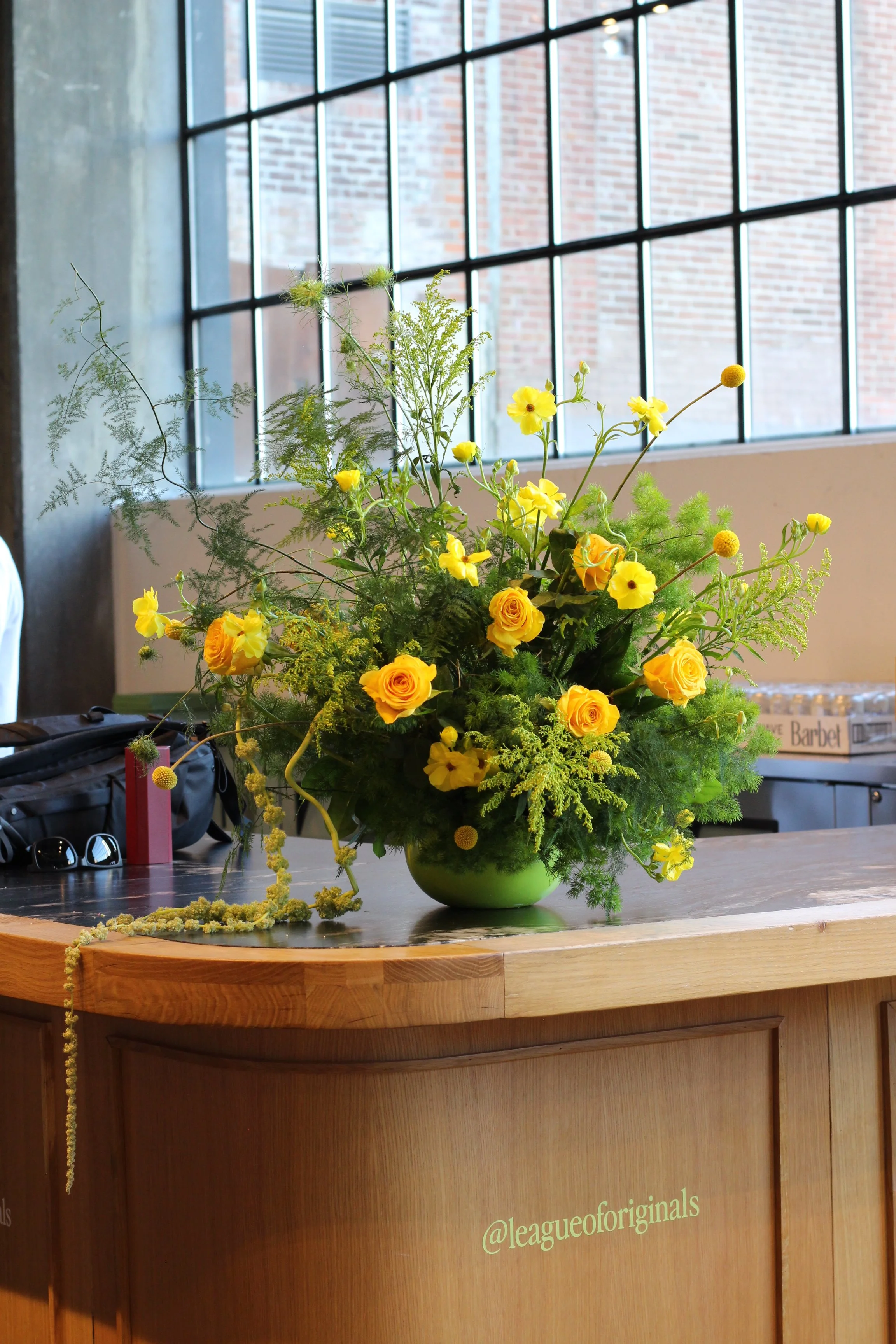 Derêves Studio team installing a custom floral installation for a Toronto corporate event