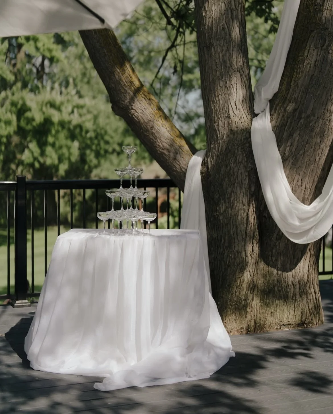 Champagne glasses arranged in a pyramid on a table covered with a white cloth | Champagne tower for rent Toronto