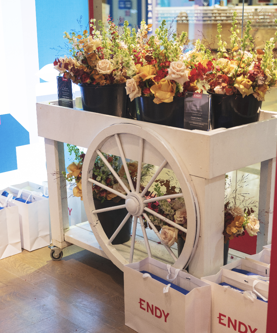 Branded flower bar setup for a Toronto product launch with seasonal flowers and custom signage