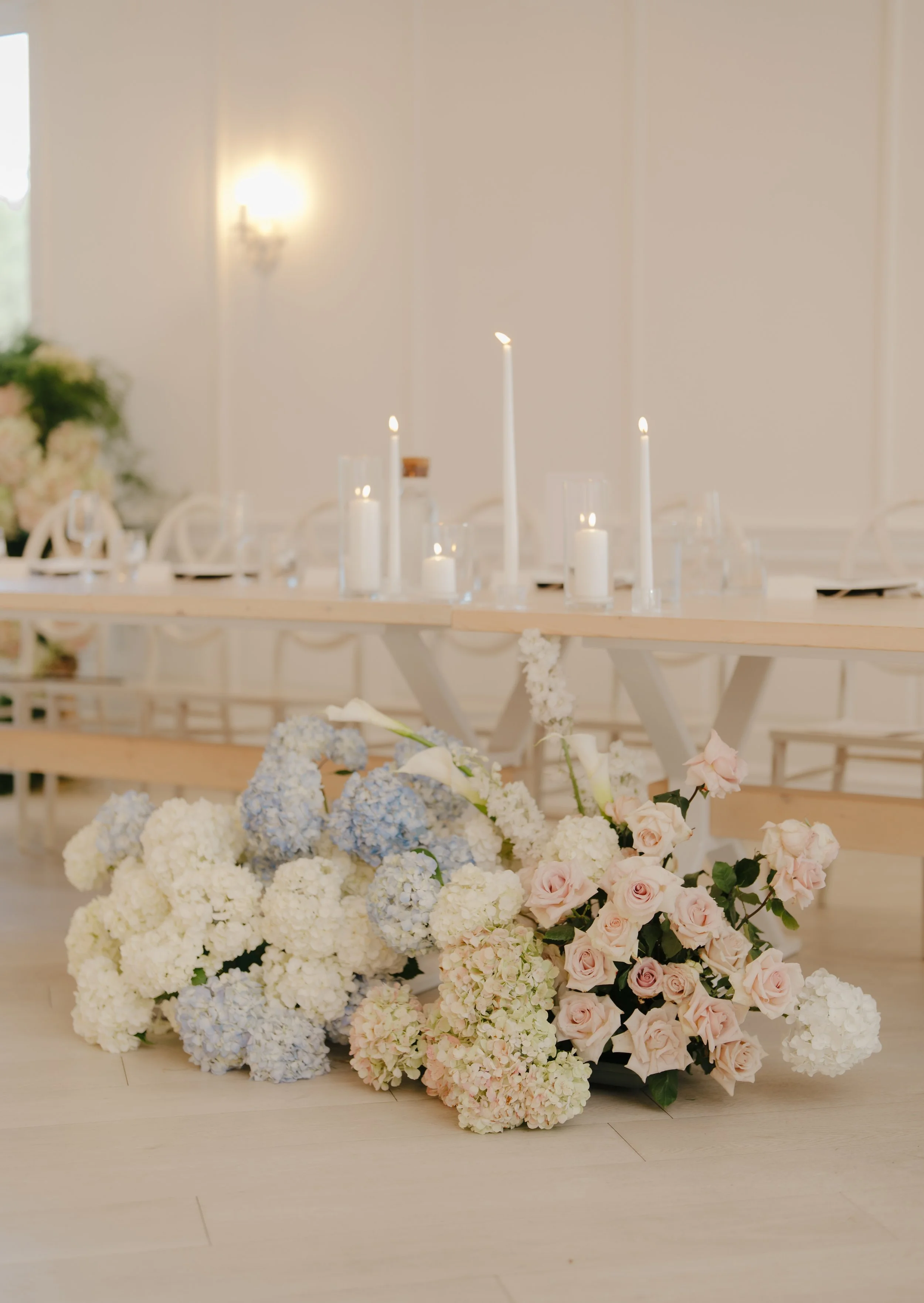 Classic white centerpiece with rich textures designed by Dereves Studio, best florist in Toronto for timeless reception styling.