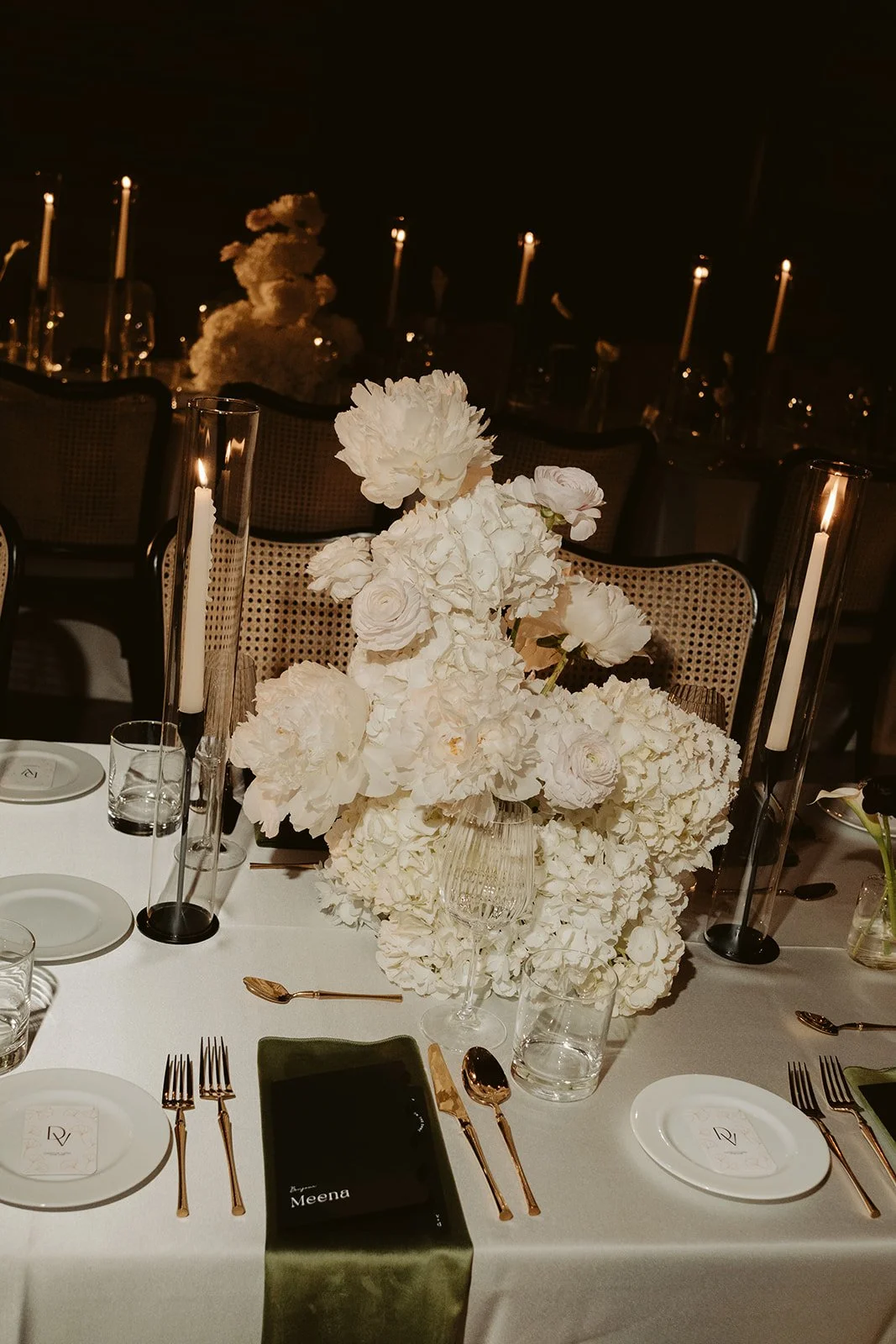 Refined wedding tablescape with full floral centrepieces, candles and intentional décor created as part of a cohesive Toronto wedding planning and design experience.