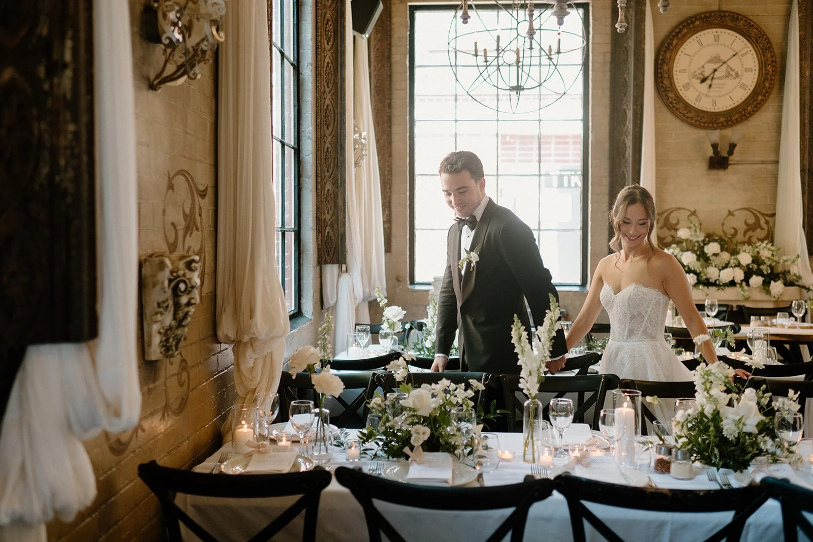 Elegant long-table centerpiece crafted by Dereves Studio featuring layered florals and candles for elevated Toronto weddings.