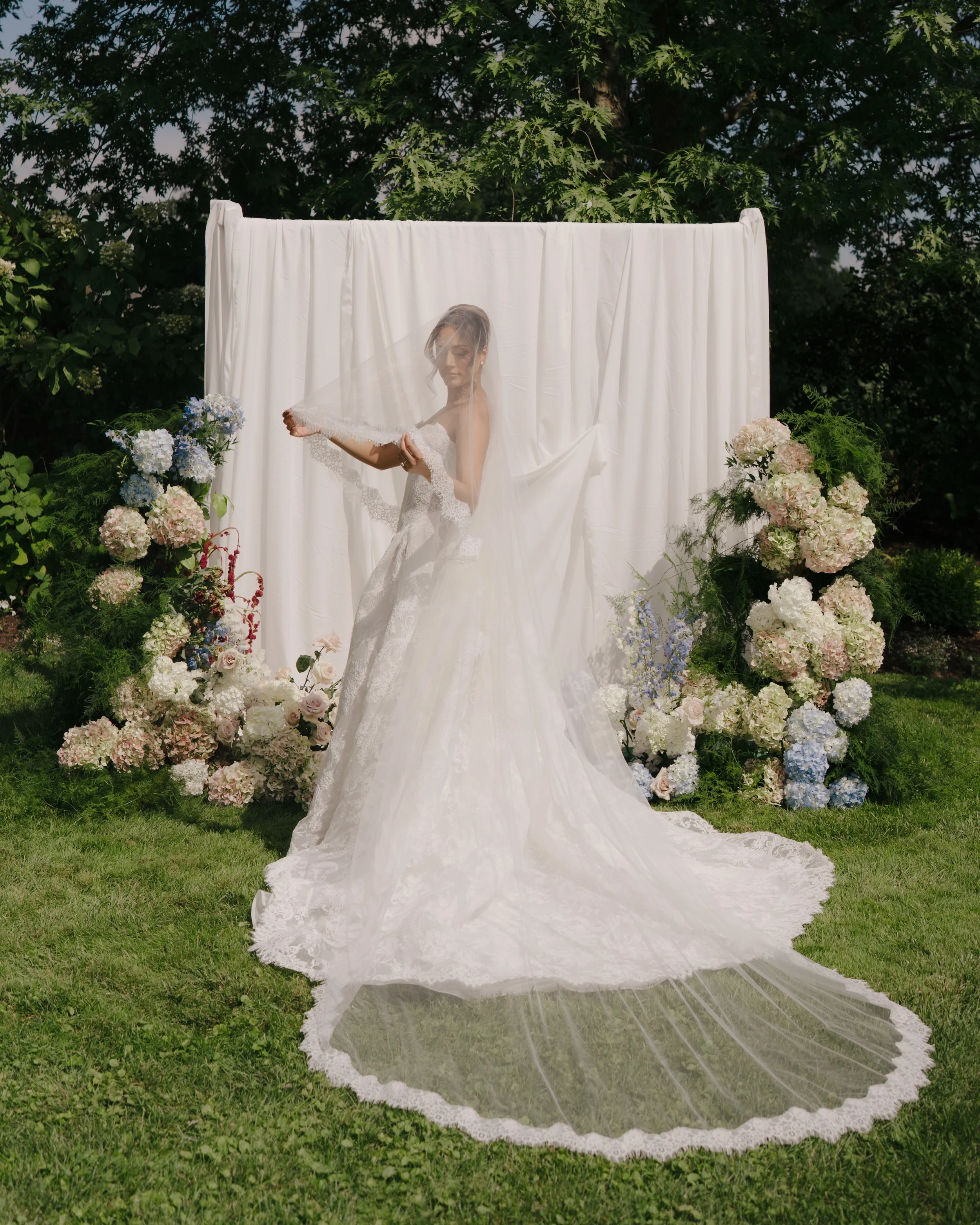Draped wedding installation with lush florals designed by Dereves Studio for elevated Toronto wedding décor