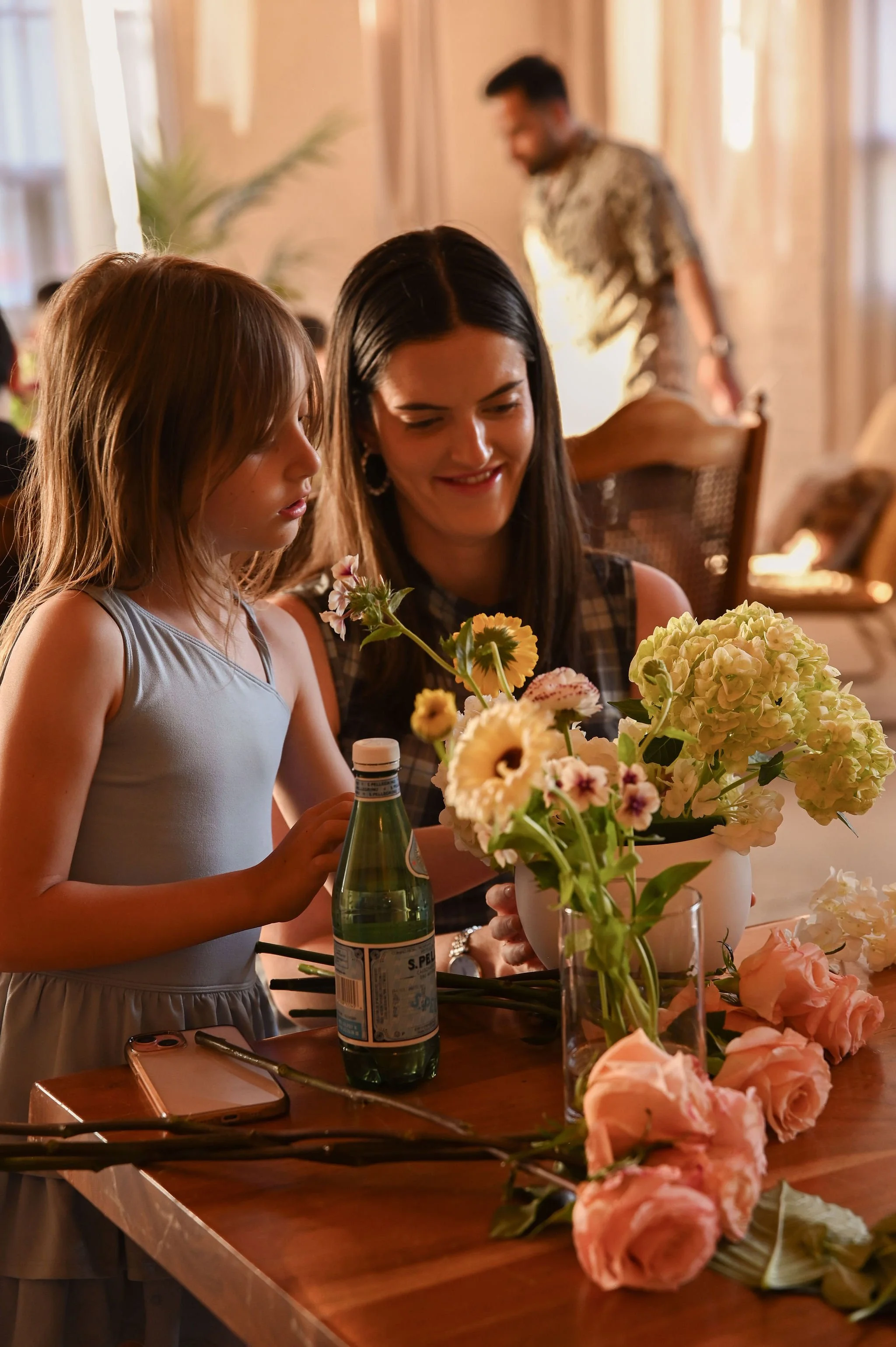 A curated floral workshop table with fresh flowers, vessels, and design tools in Toronto.