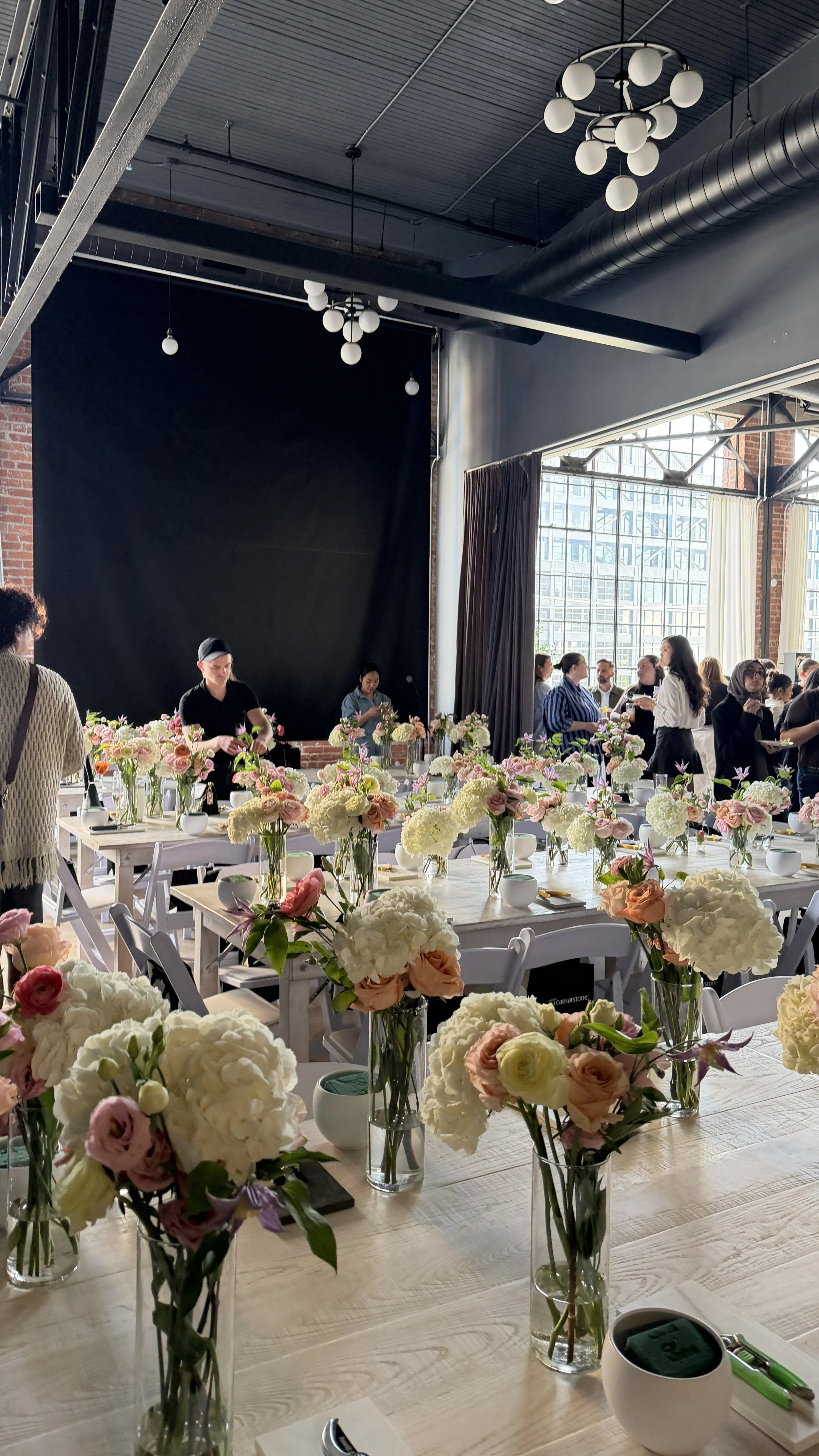 Guests creating fresh floral arrangements at a private corporate flower workshop in Toronto for Caesarstone’s client appreciation event.