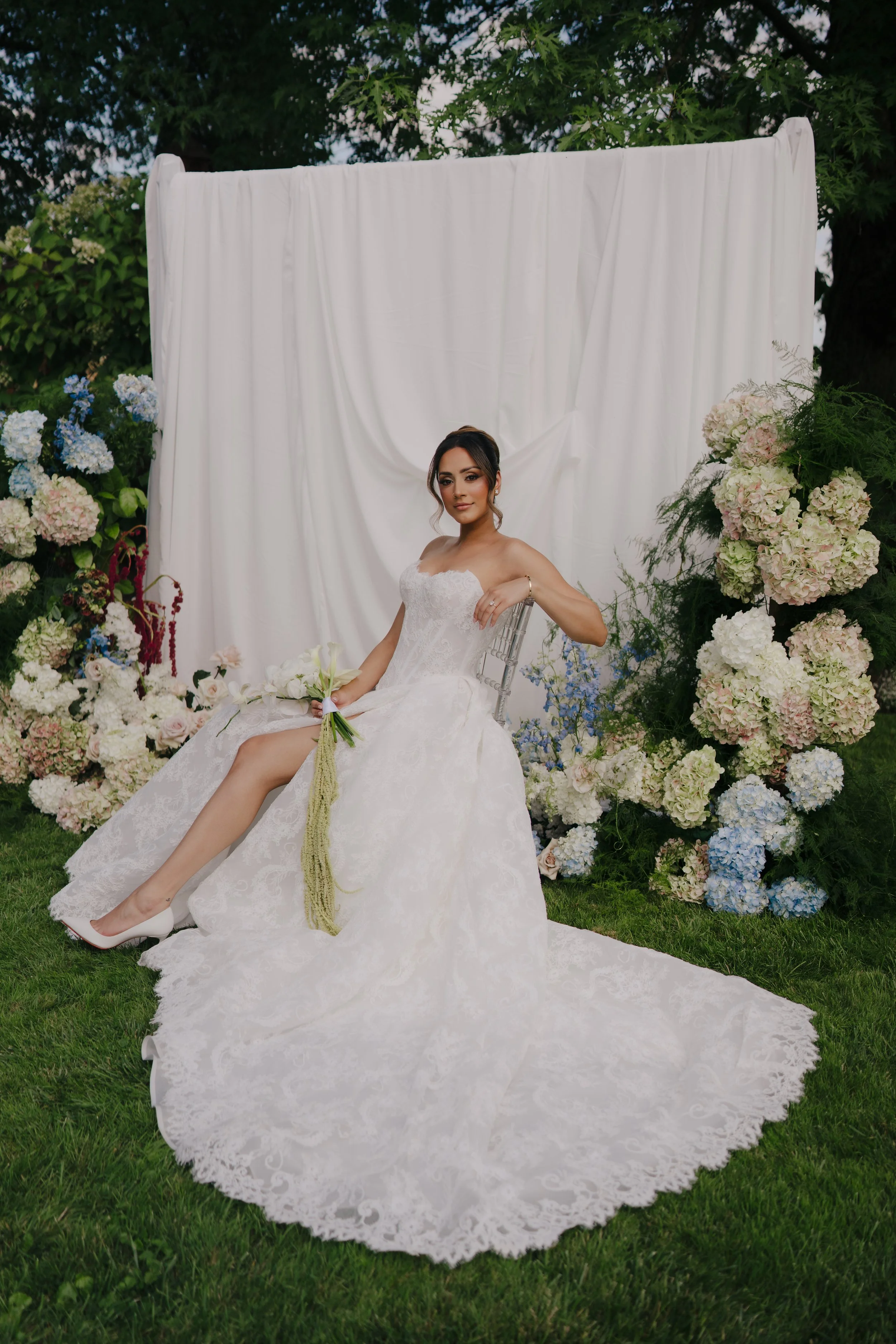Elegant draped ceremony backdrop with soft white florals designed by Dereves Studio, Toronto wedding planner for luxury events.