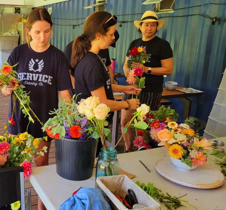 Volunteers arranging bouquets of farm-grown flowers