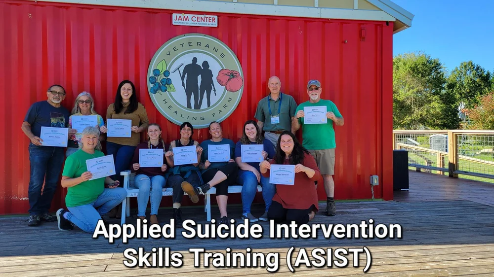 Graduates holding certificates from an Applied Suicide Intervention Skills Training (ASIST) class at the farm