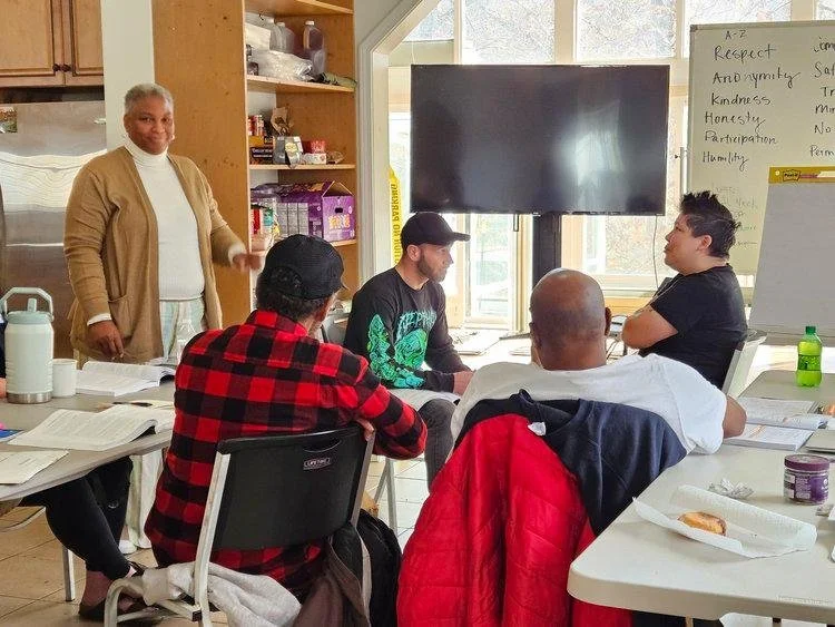 Veterans gathered around tables during an indoor workshop