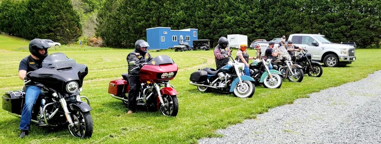 Motorcycles parked on the lawn during a farm event