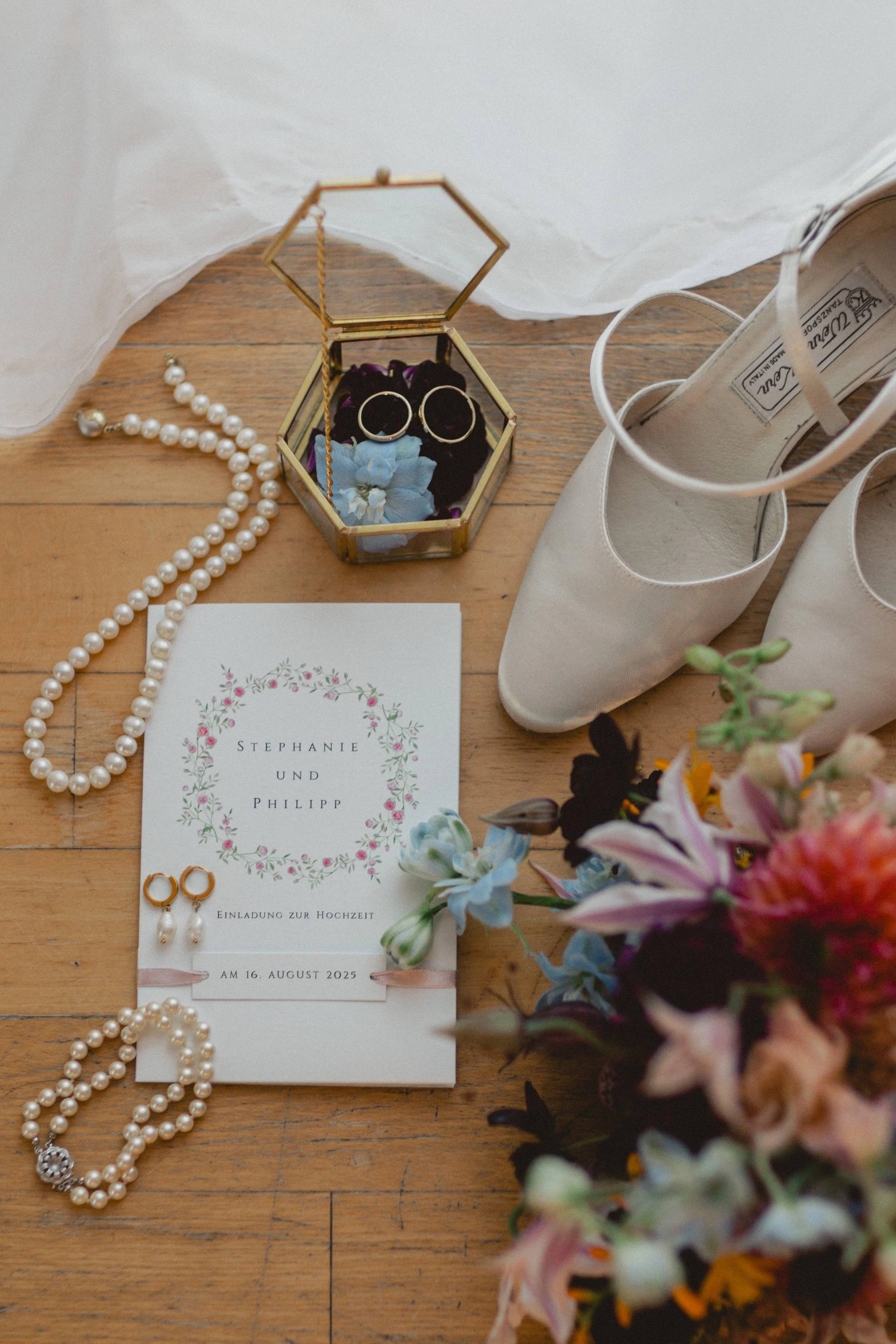 Braut und Bräutigam spazieren Hand in Hand durch einen Schlossgarten in Bayern, zeitlose Hochzeitsfotografie mit romantischer Atmosphäre. Bride and groom walking hand in hand through a castle garden in Bavaria, timeless wedding photography with a rom