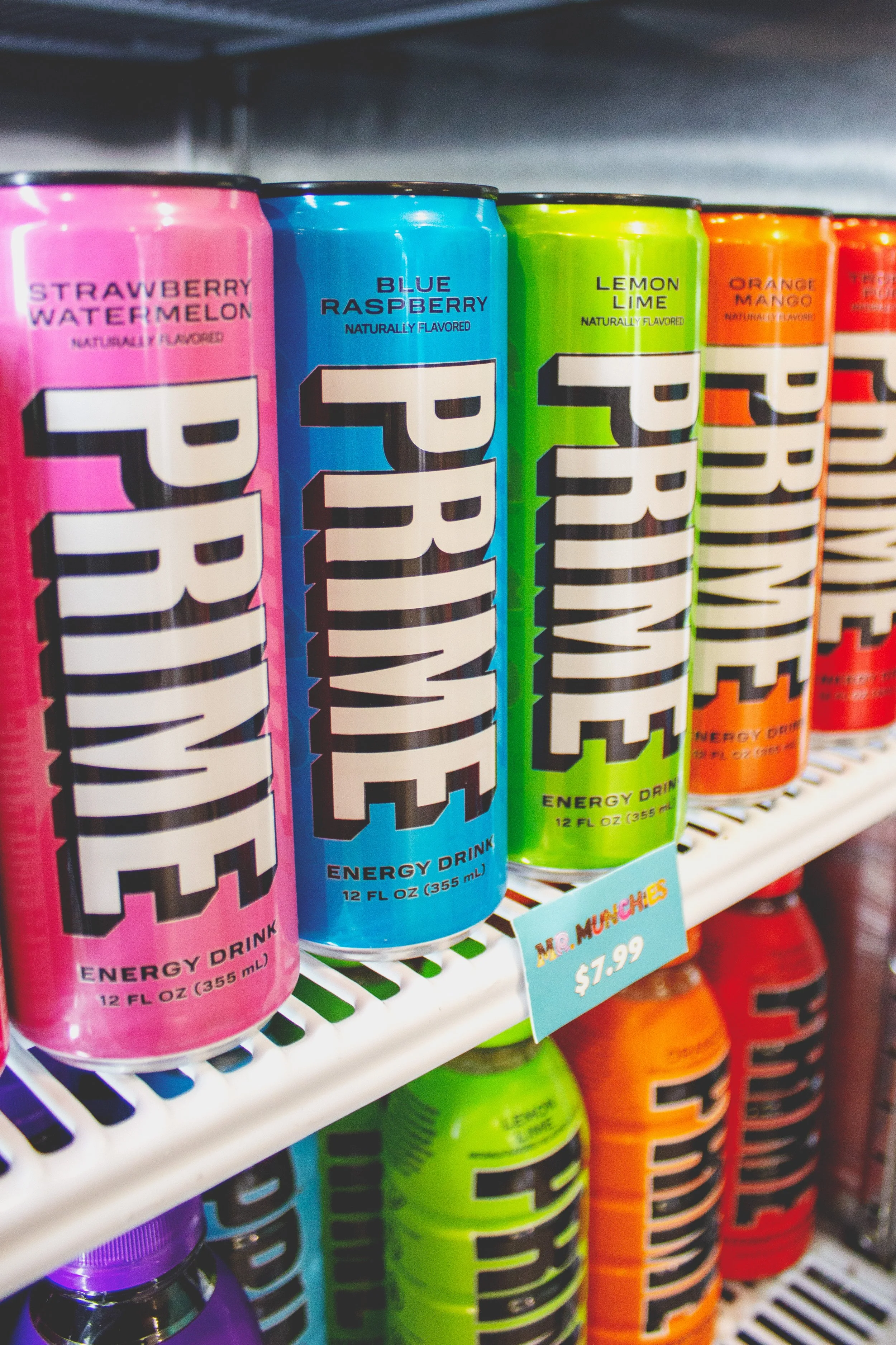 Colourful Prime Energy Drink cans line shelves