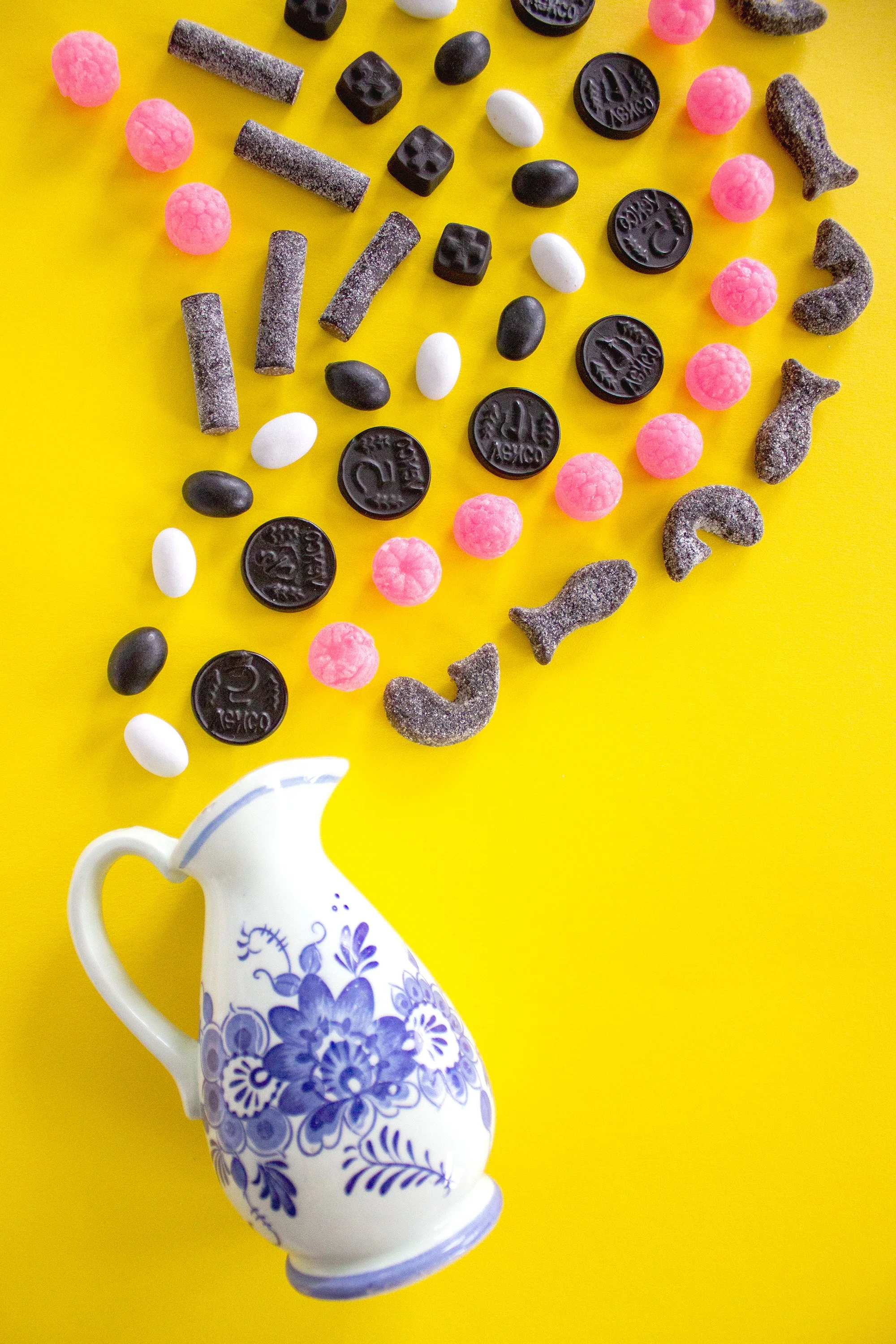 A delft blue jug pour vibrant liquorice candy