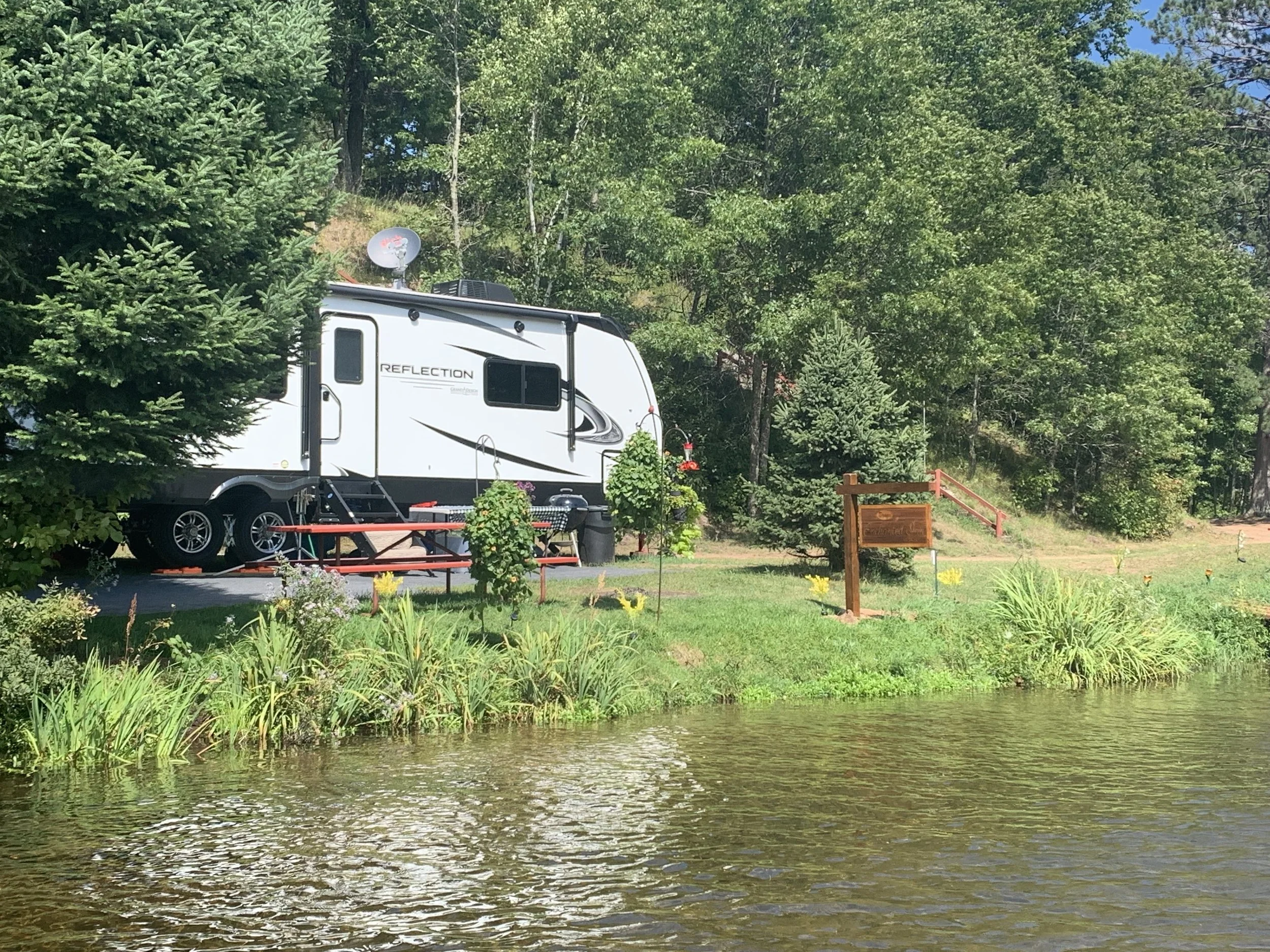 waterfront campsite with camper