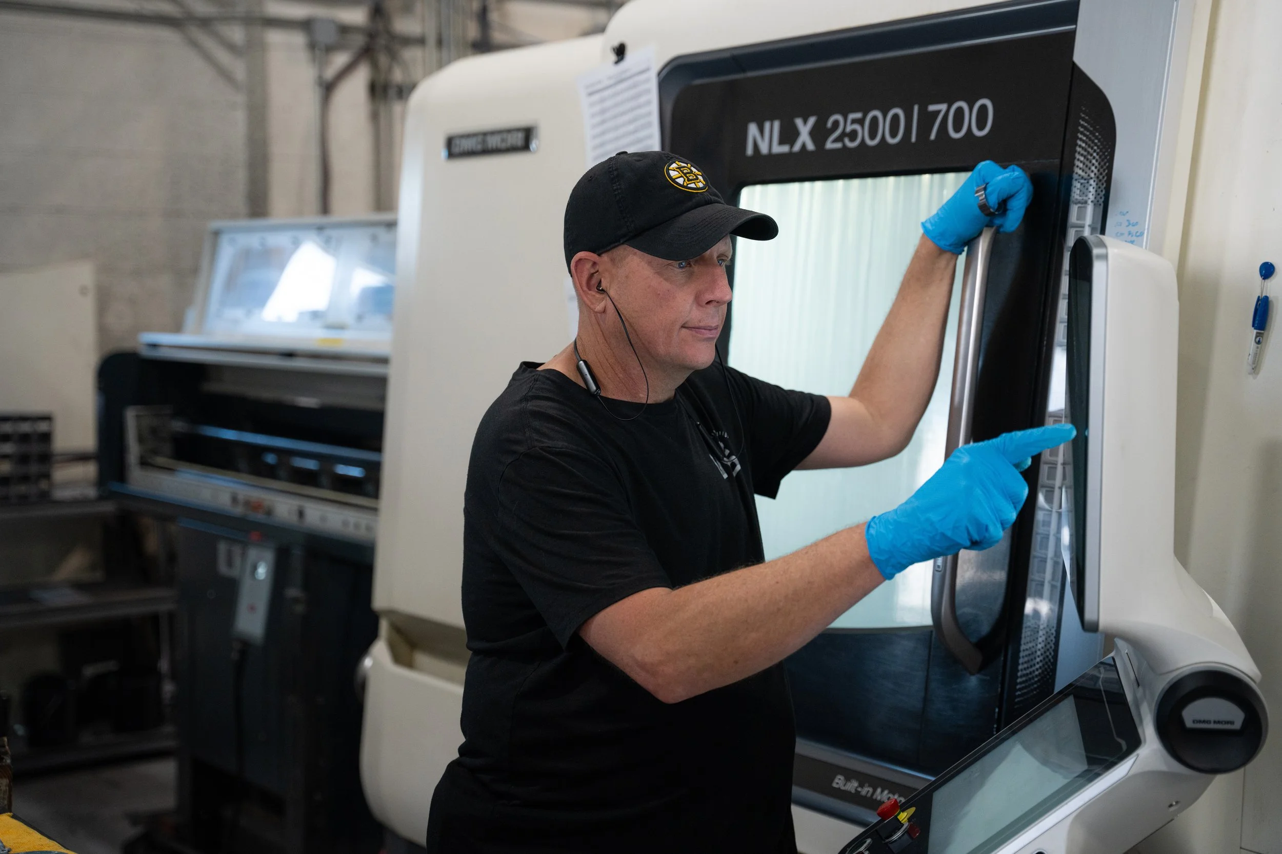 IPC Machining Team member at the controls of a DMG Mori NLX 2500