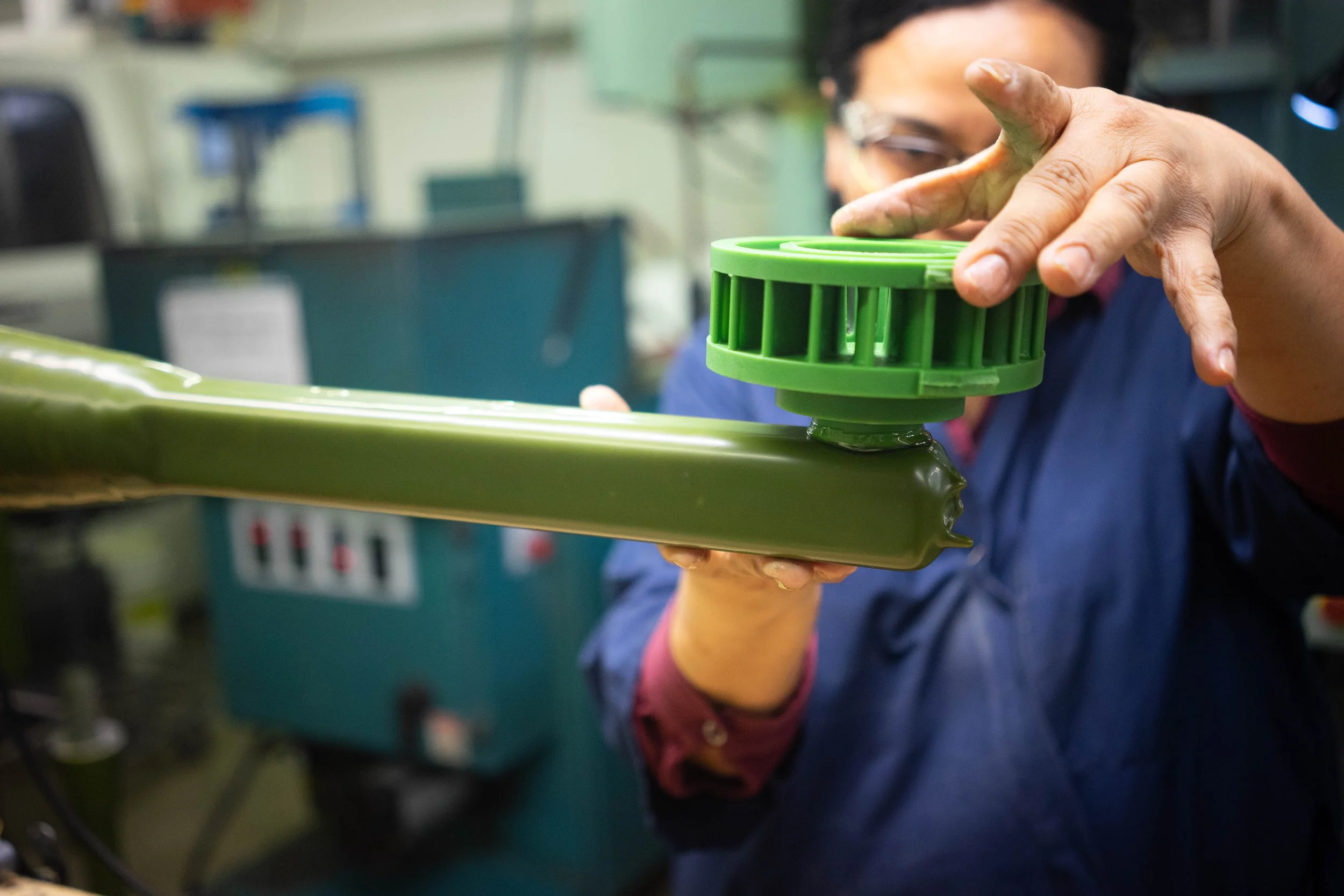 A foundry worker securing a gating system to a wax pattern.