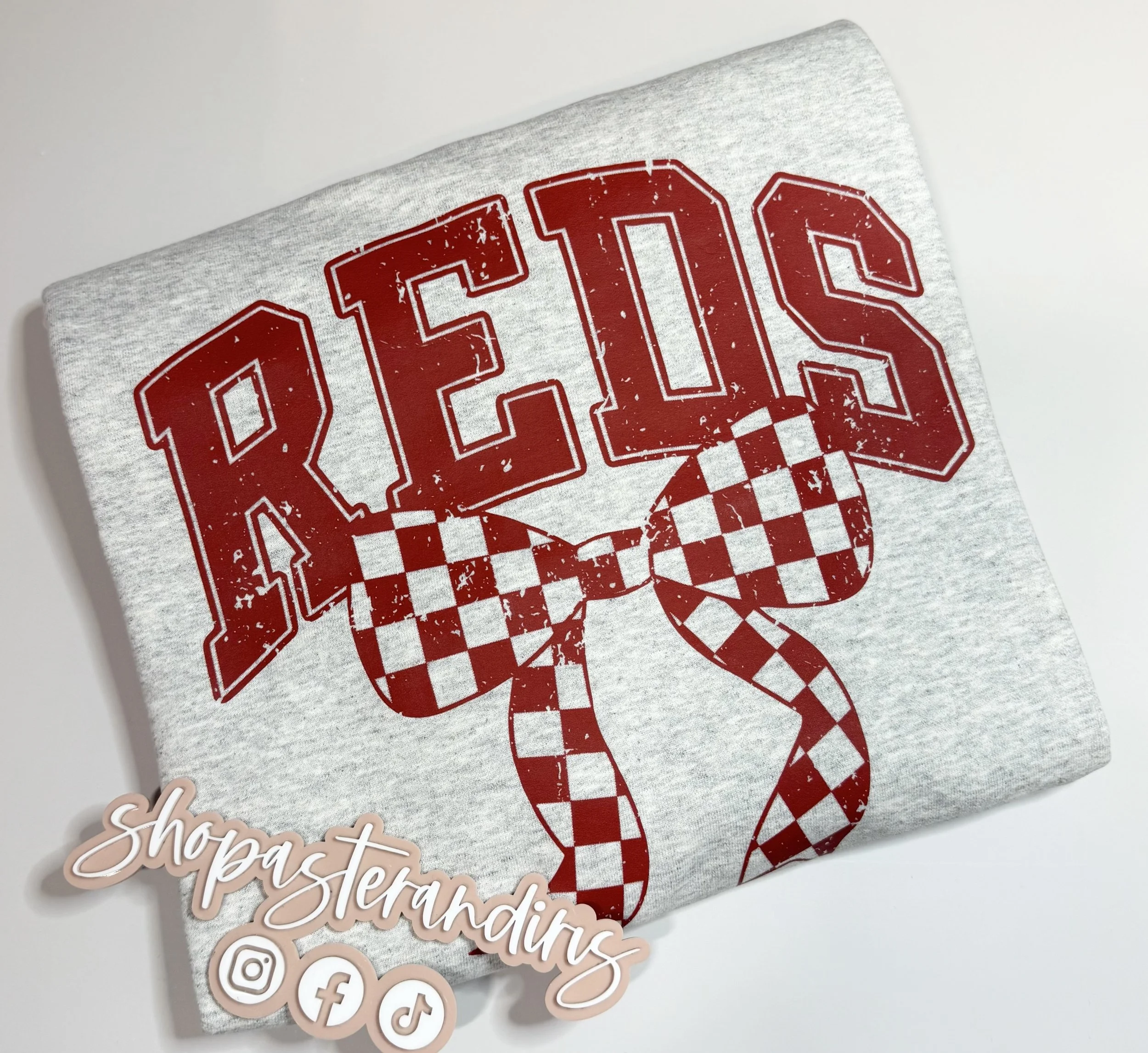 Reds with checkered bow crewneck