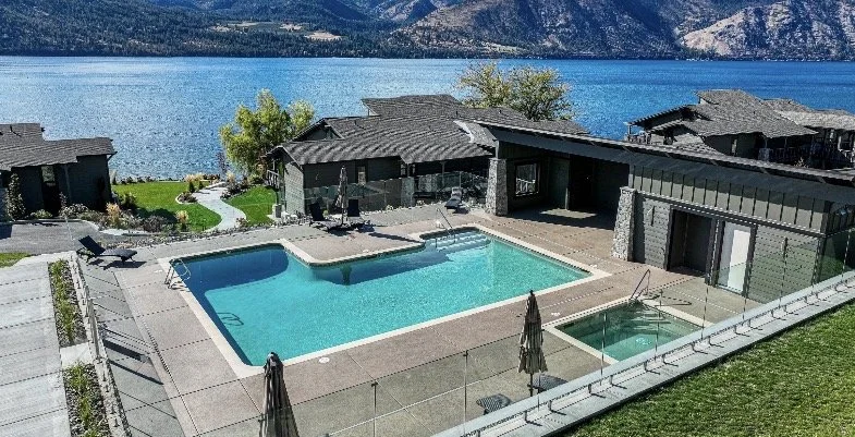 From the F Building deck, the refreshed pool area feels close and inviting, with the shimmering pool at the center, the hot tub quietly tucked nearby, and the newly updated pool house tying the space together. From this vantage point, the scene blend