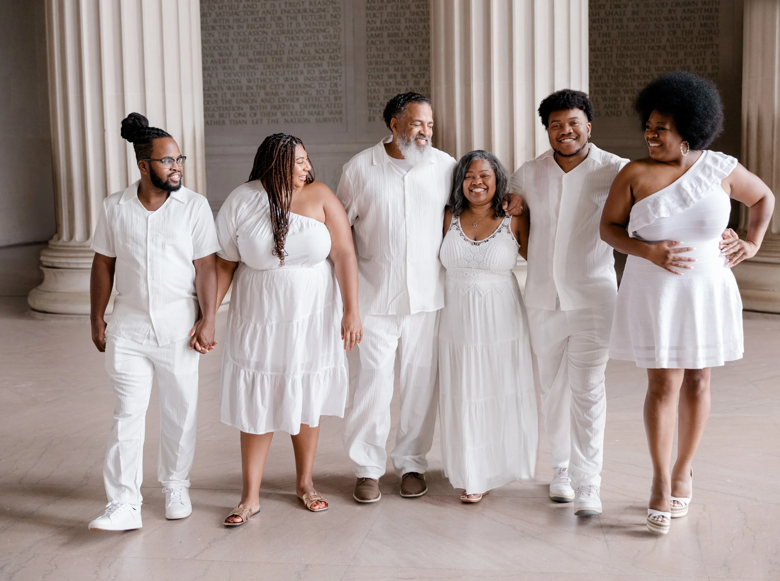 Family photo session with white outfits at the Lincoln Memorial