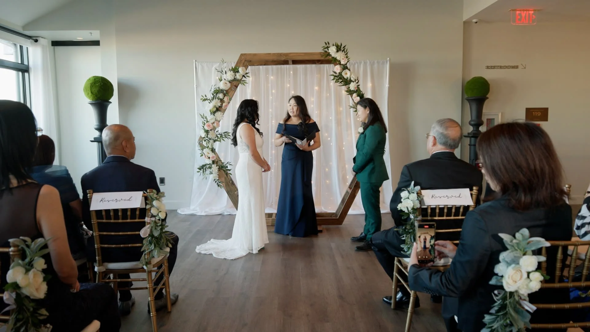 Wedding ceremony with three women standing at the altar at a wedding in the Riggs hotel in Washington DC.