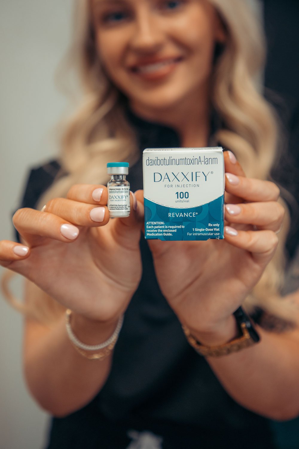 Provider holding a vial of Daxxify — what is Daxxify? It's an FDA-approved, peptide-based neurotoxin with longer-lasting results.