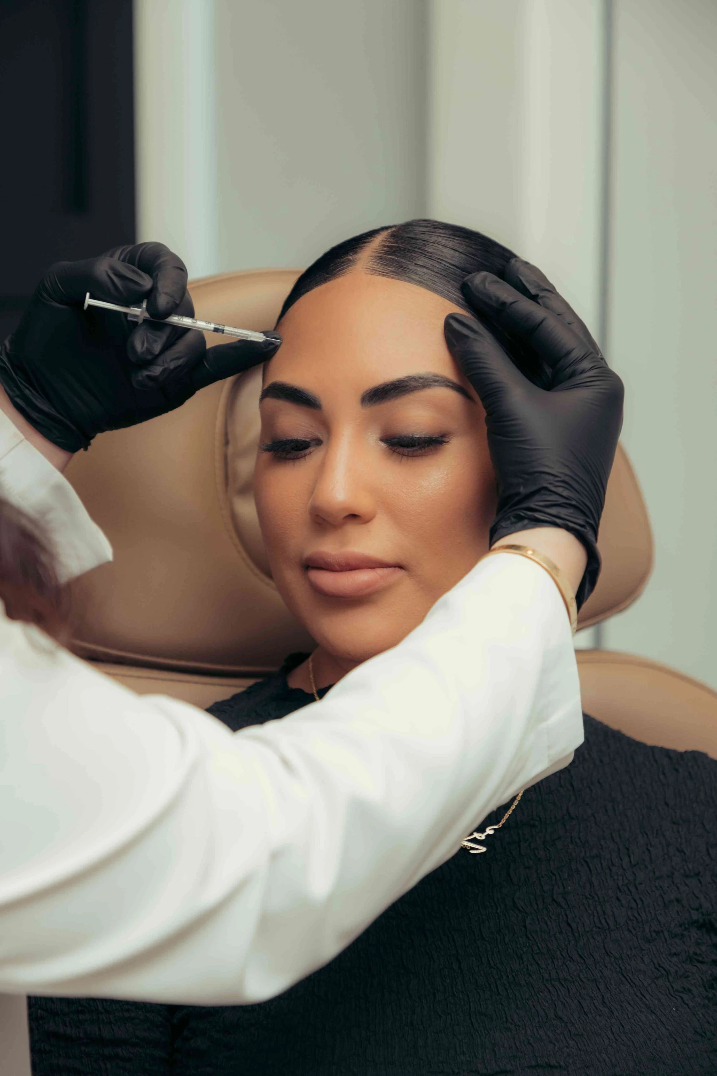 A patient getting Daxxify injections in the forehead to reduce wrinkles and lines.