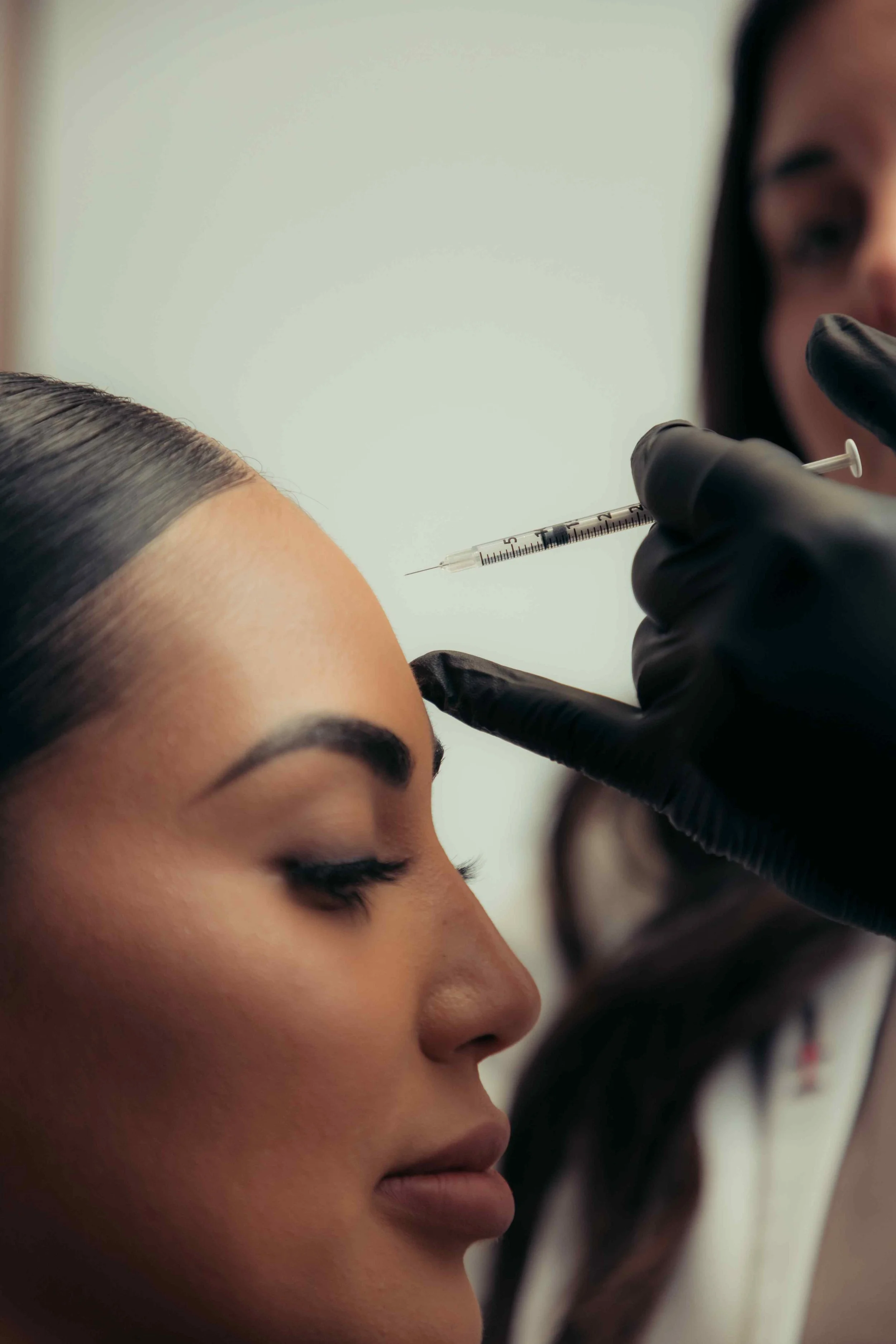 A patient getting Daxxify injections in the forehead to reduce wrinkles and lines.