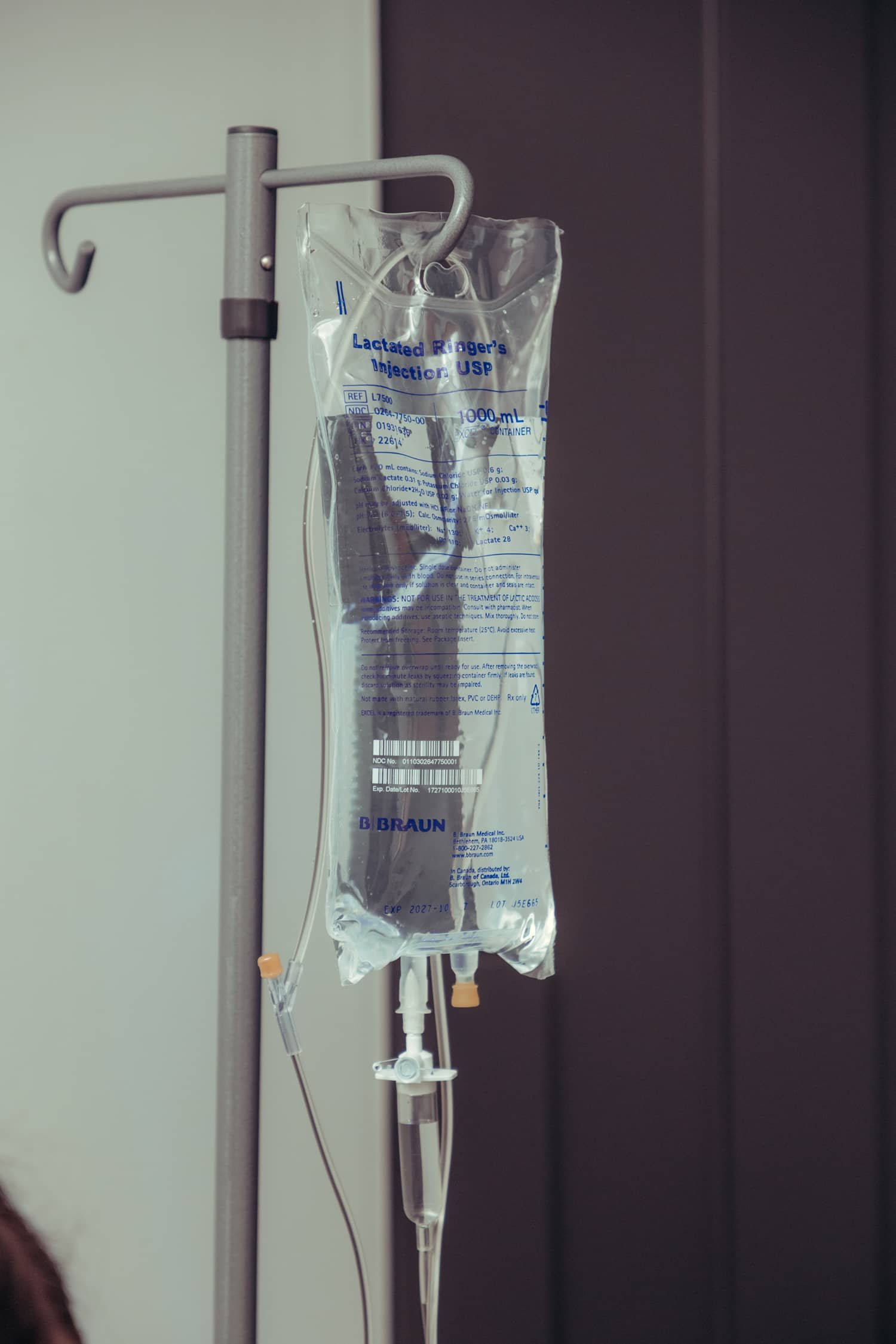 IV bag hanging on infusion pole, used for NAD+ IV therapy at Injx Bar.