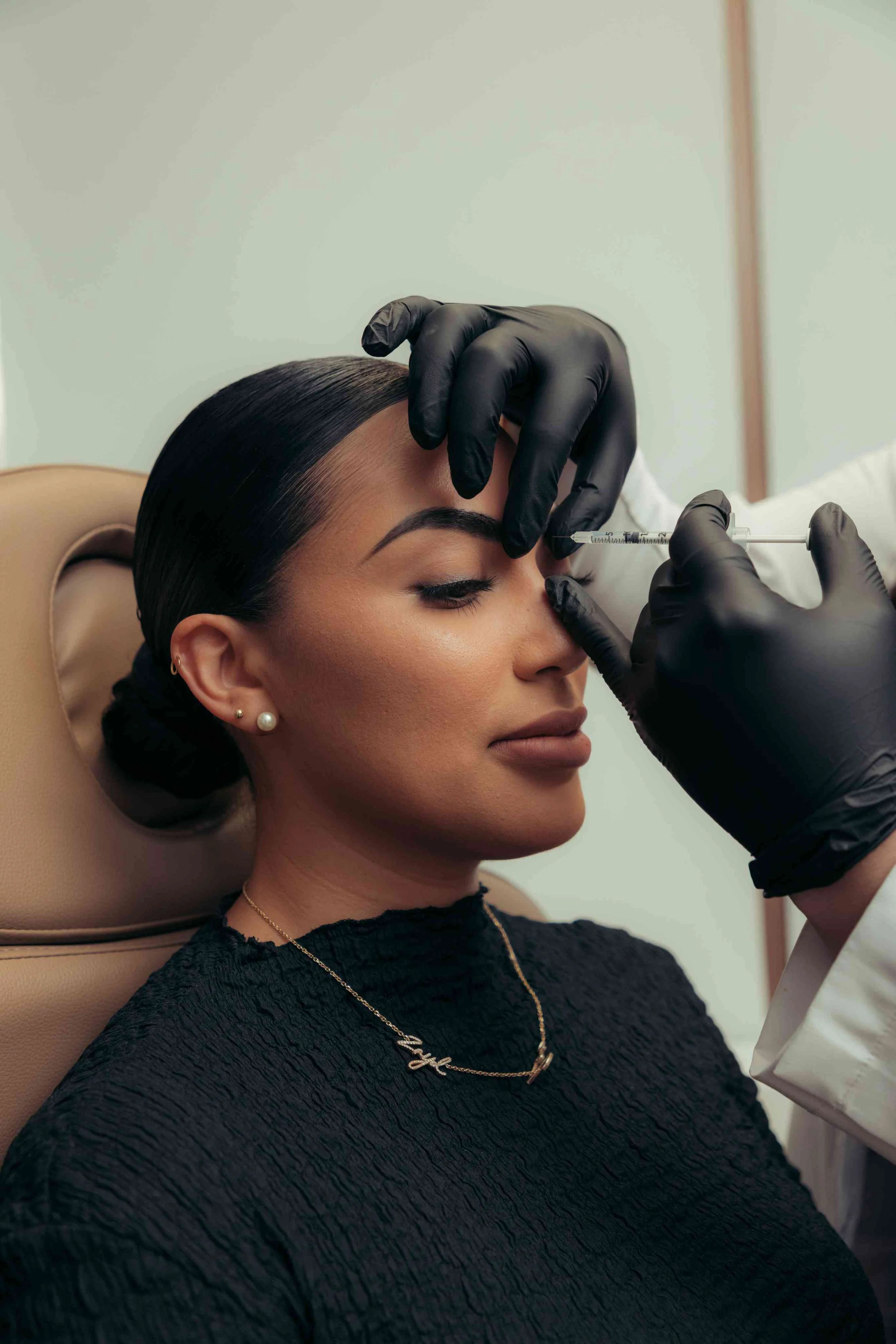 A patient getting Dysport injections to relax and smooth her frown lines.