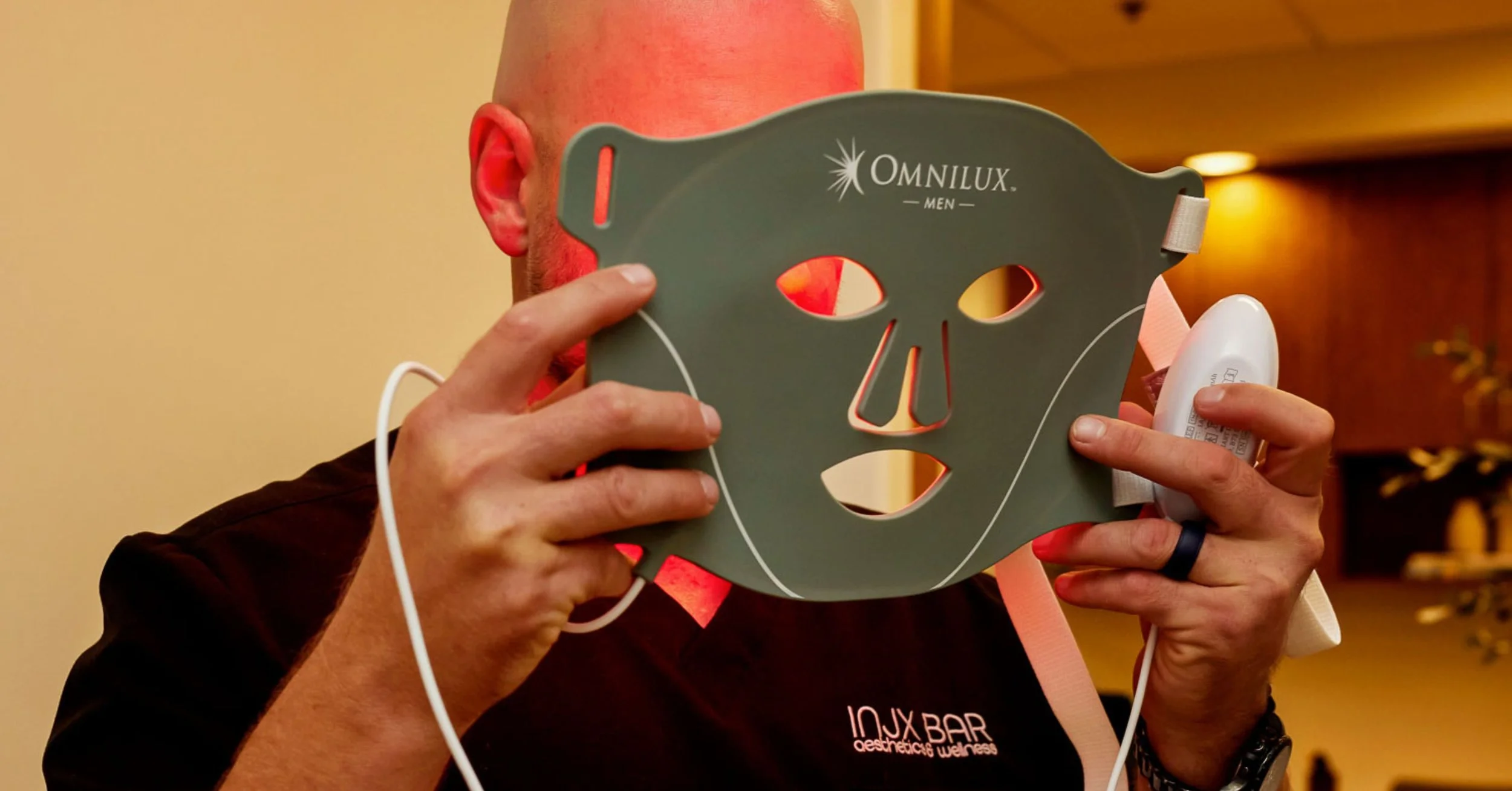 Male during a red light therapy session highlighting benefits including improved skin tone, reduced fine lines, and faster healing.